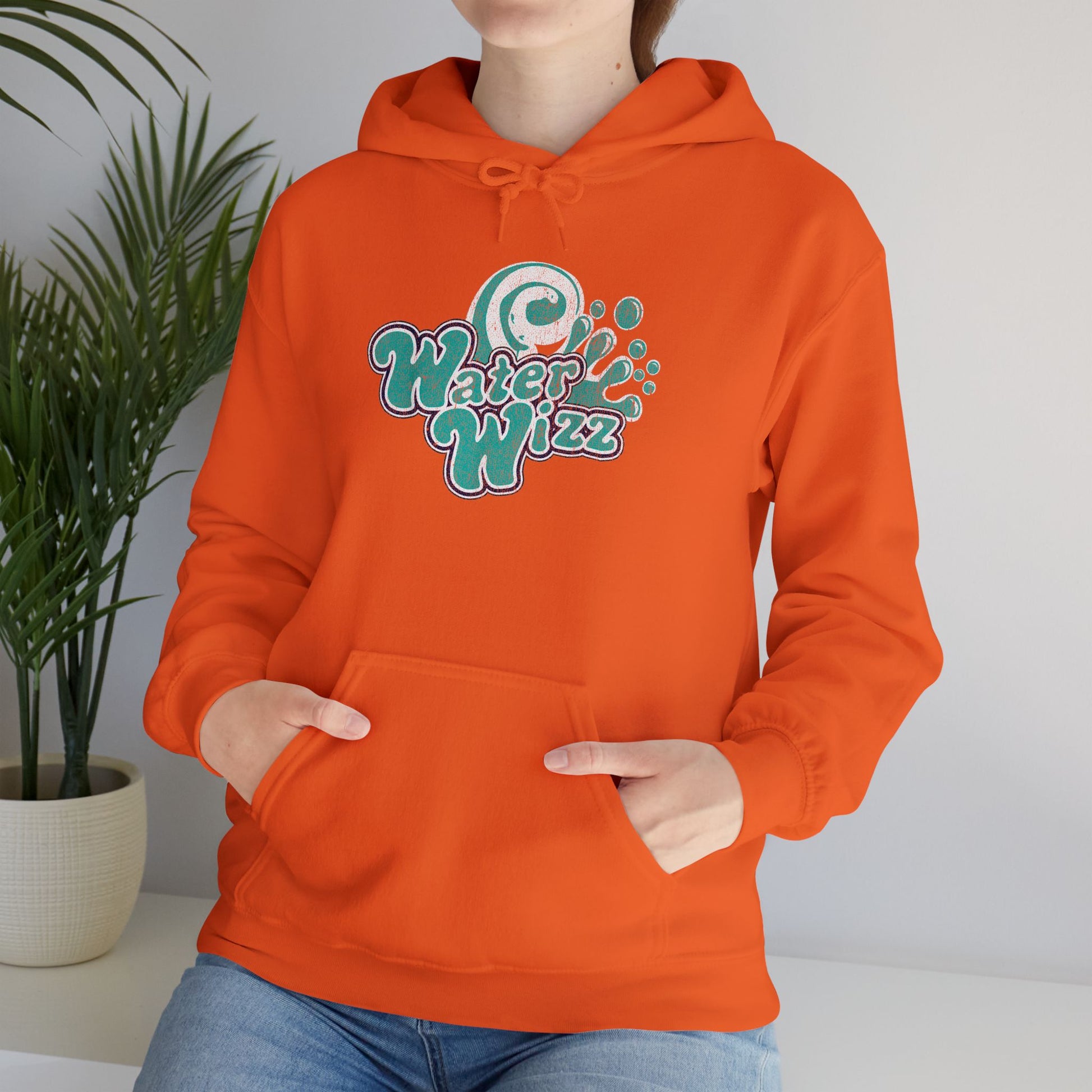 Woman wearing orange Gildan 18500 pullover hoodie with vintage distressed Water Wizz logo from Grown Ups on the chest.