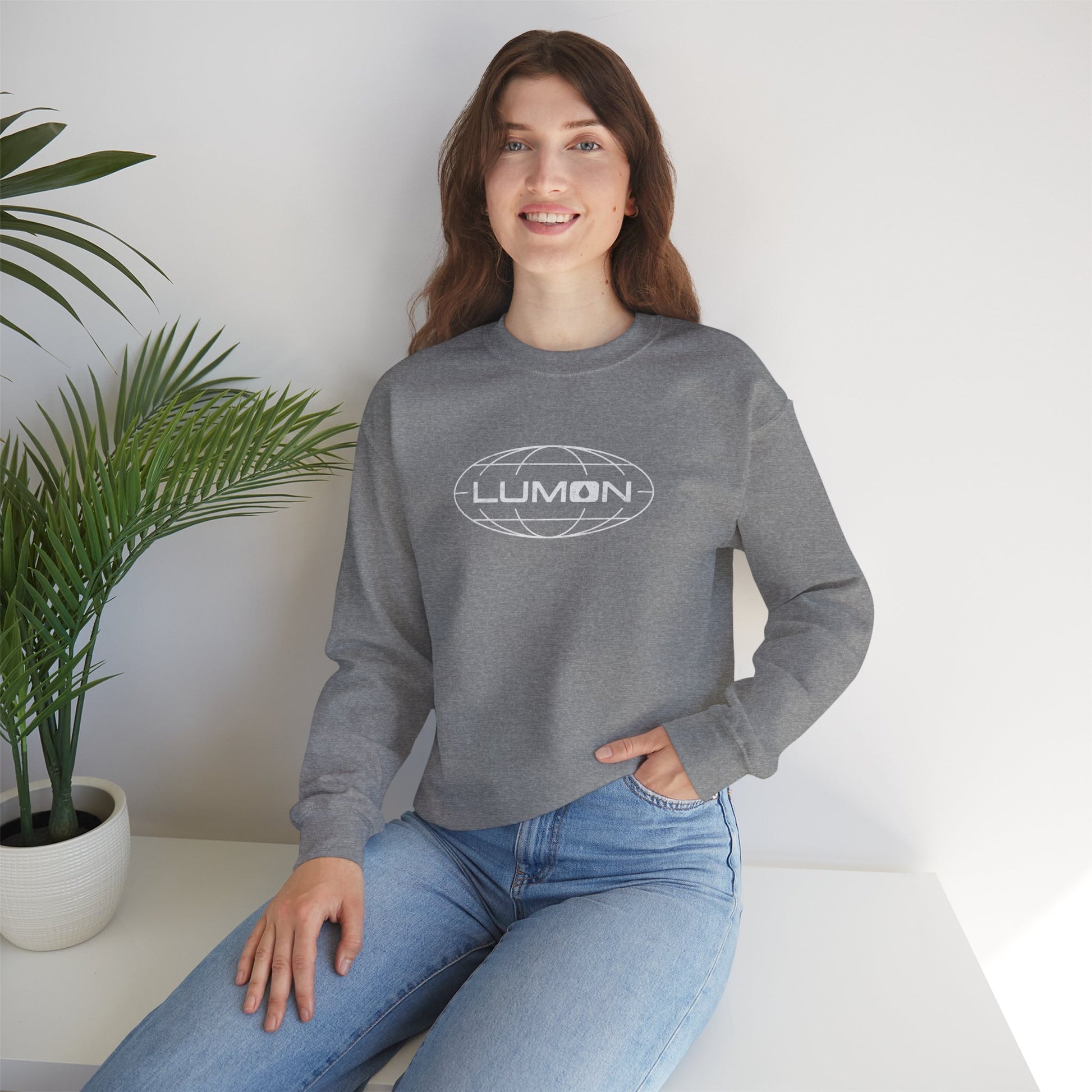 Female model wearing a heather gray Soft Gildan 18000 crew neck sweatshirt featuring the Lumon Industries logo from the Apple TV show Severance in a vintage distressed style.
