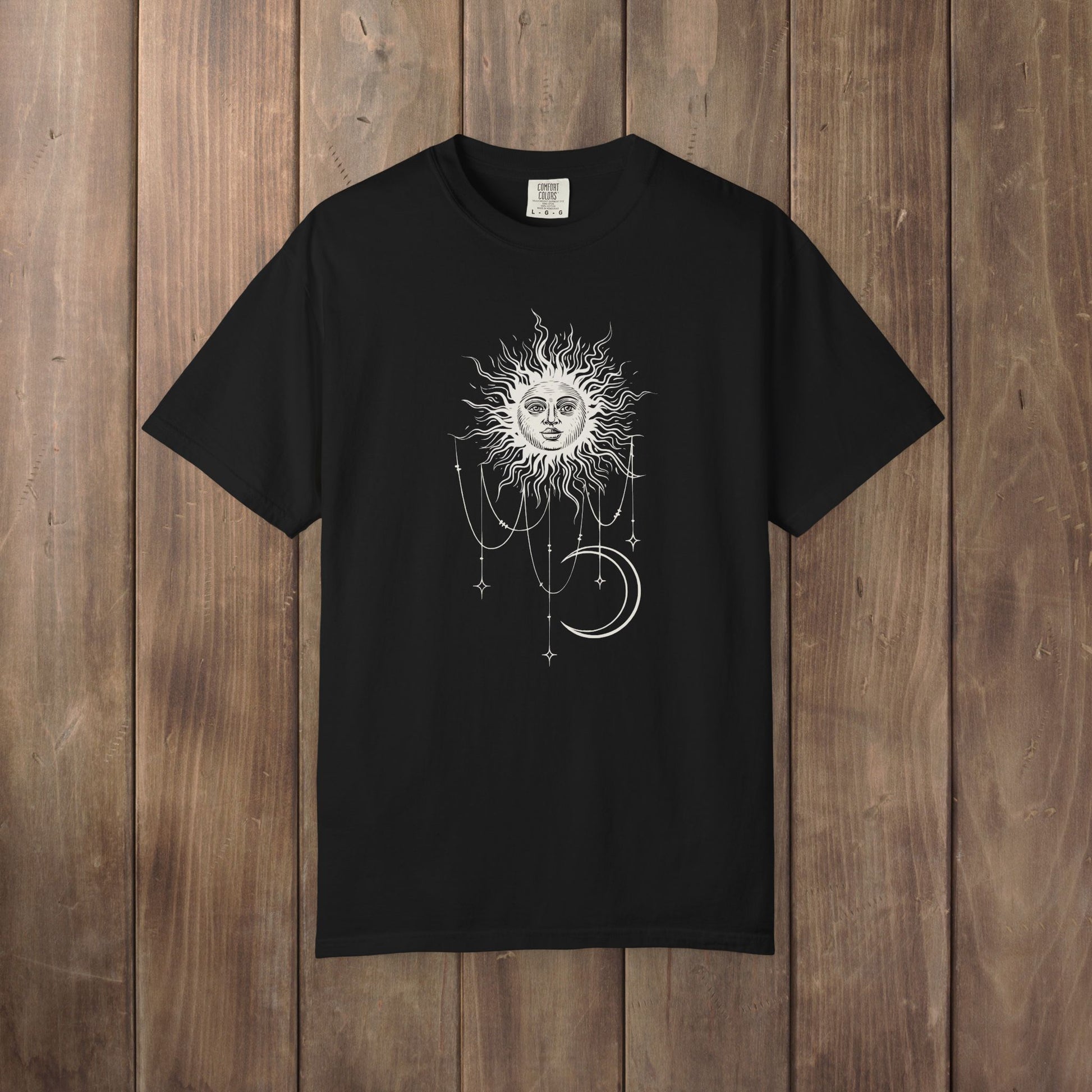 Black Comfort Colors tee with a celestial sun and crescent moon design, worn by Patricia in Widow's Bay S1E8