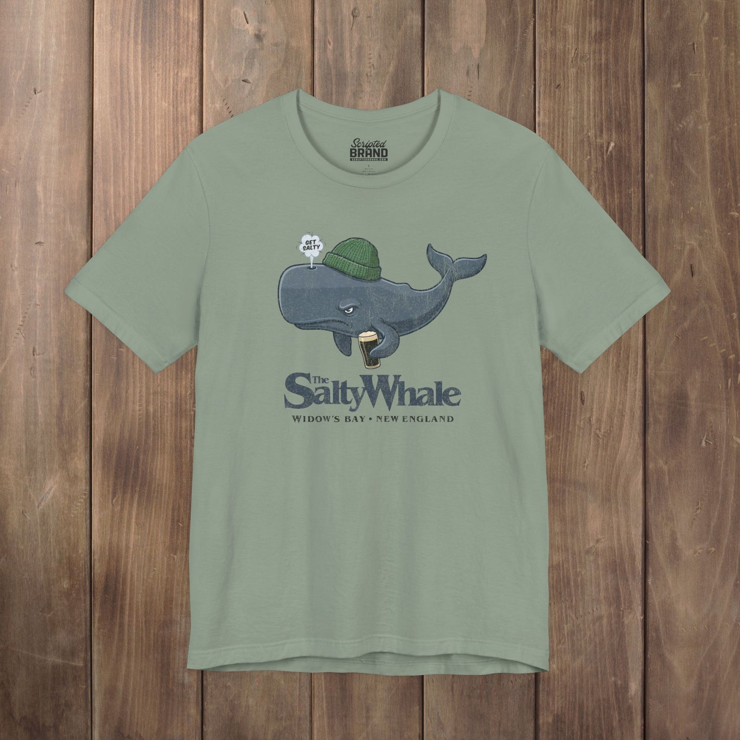Sage green 'The Salty Whale' cartoon mascot t-shirt inspired by Widow's Bay Apple TV series, soft Bella+Canvas cotton pub fan tee