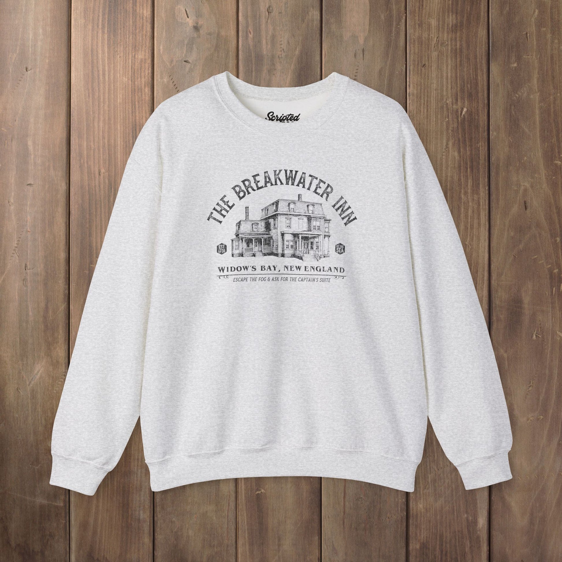 Ash crewneck sweatshirt with Breakwater Inn Widow's Bay New England hotel graphic