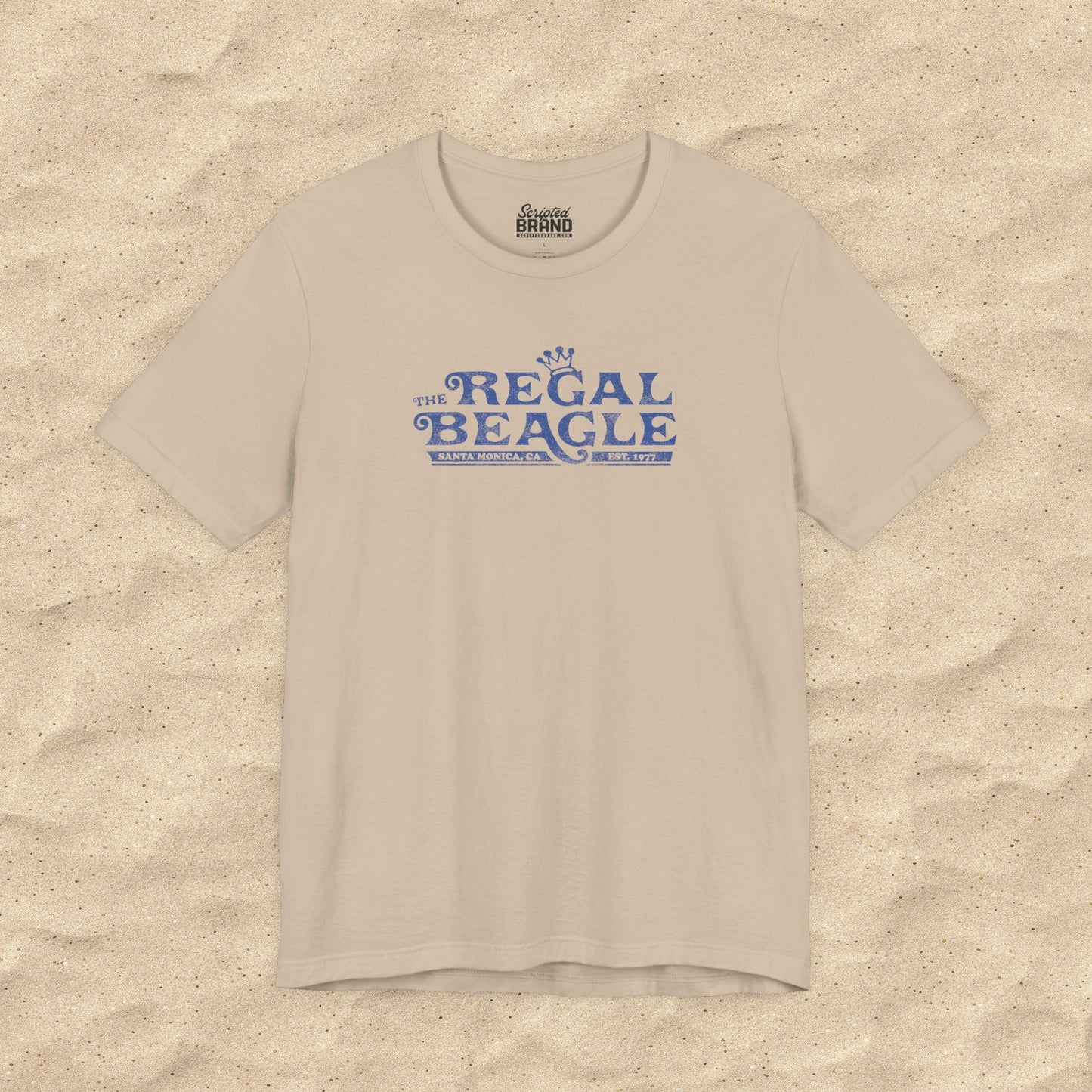 Tan Bella+Canvas t-shirt with the Regal Beagle logo from the TV Show 'Threes Company' in a vintage distressed style.