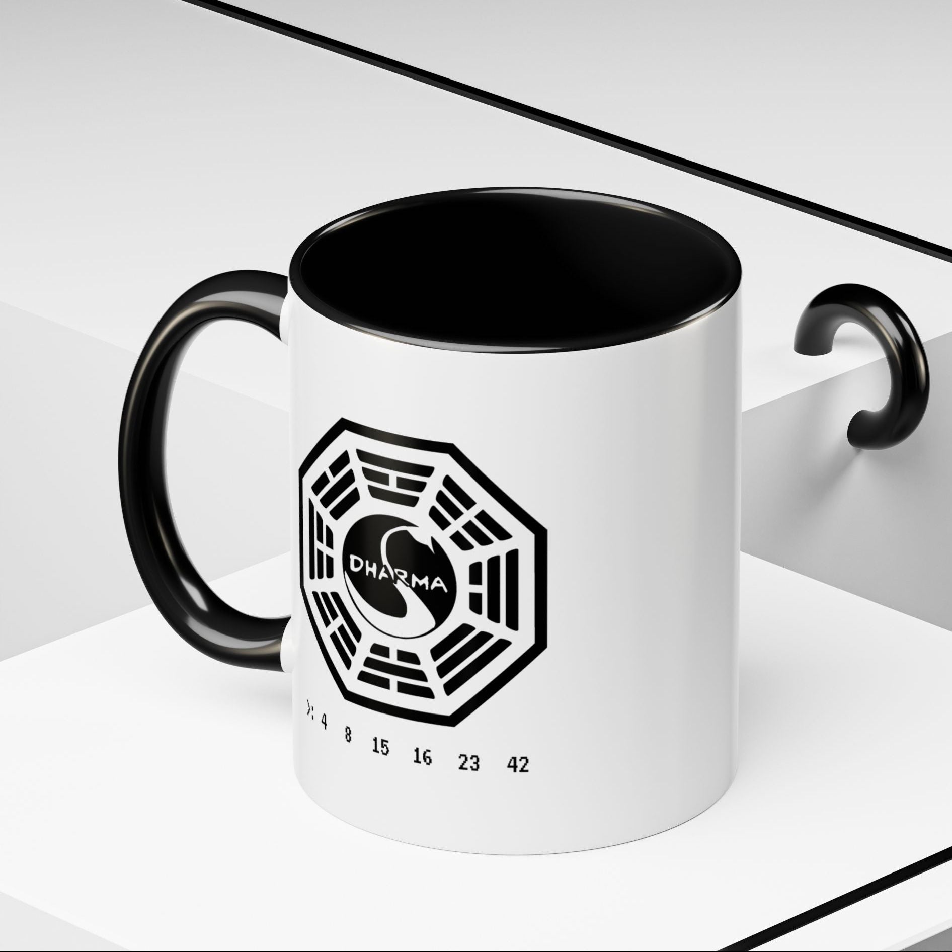 Angled view of 11 oz White ceramic Dharma Initiative Swan Station logo mug with black handle and interior, hatch numbers 4 8 15 16 23 42