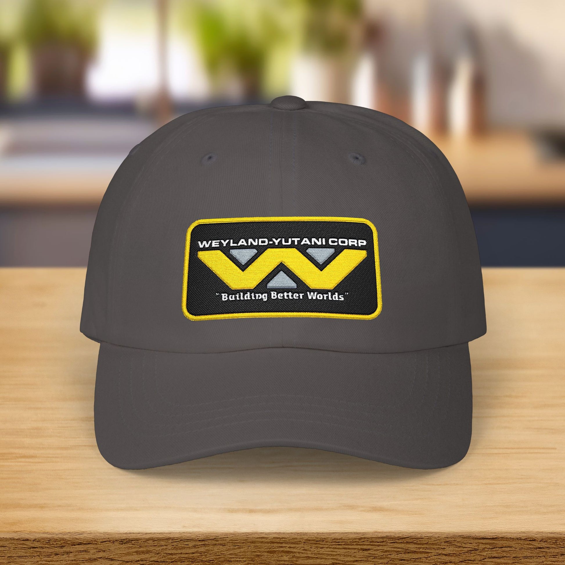 Dark grey Yupoong dad cap with embroidered Weyland-Yutani Corp patch logo from the Alien franchise in yellow and silver