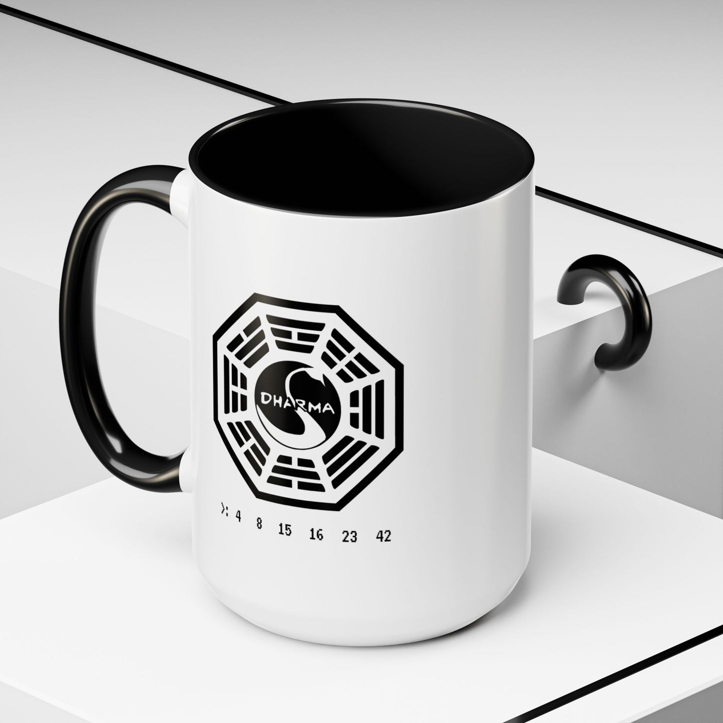 Angled view of 15 oz White ceramic Dharma Initiative Swan Station logo mug with black handle and interior, hatch numbers 4 8 15 16 23 42