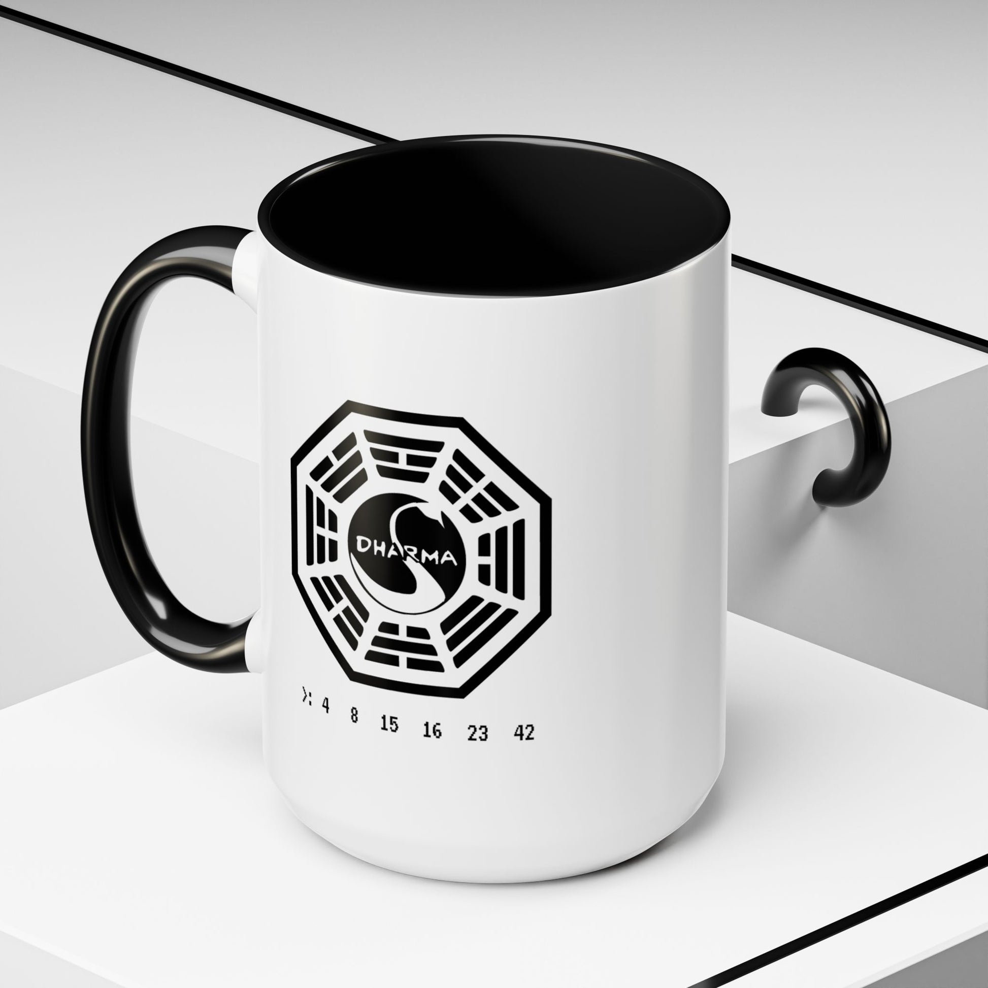 Angled view of 15 oz White ceramic Dharma Initiative Swan Station logo mug with black handle and interior, hatch numbers 4 8 15 16 23 42