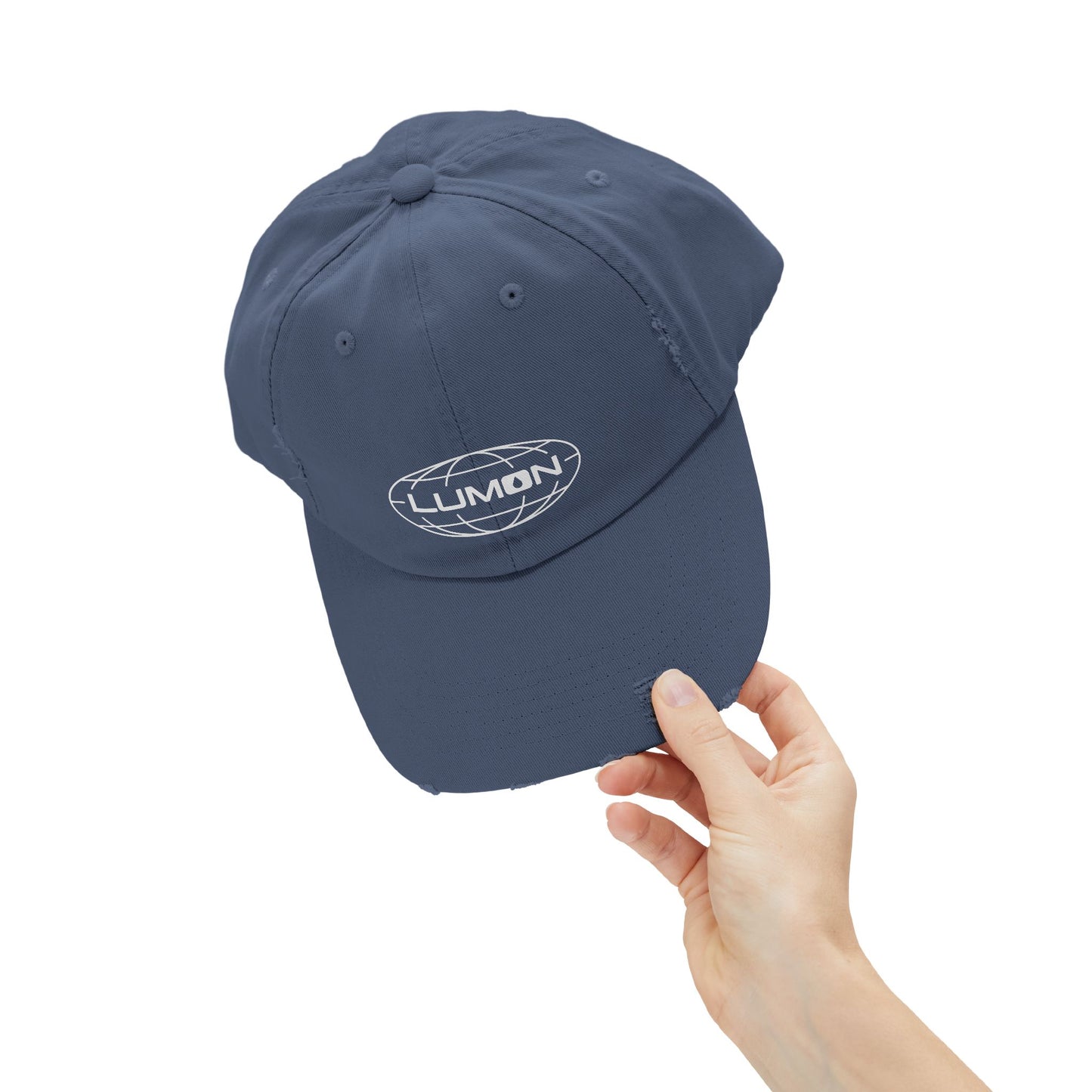 Hand holding a Scotland blue District DT600 Vintage Distressed Baseball Cap with the Lumon Industries logo from the show Severance.