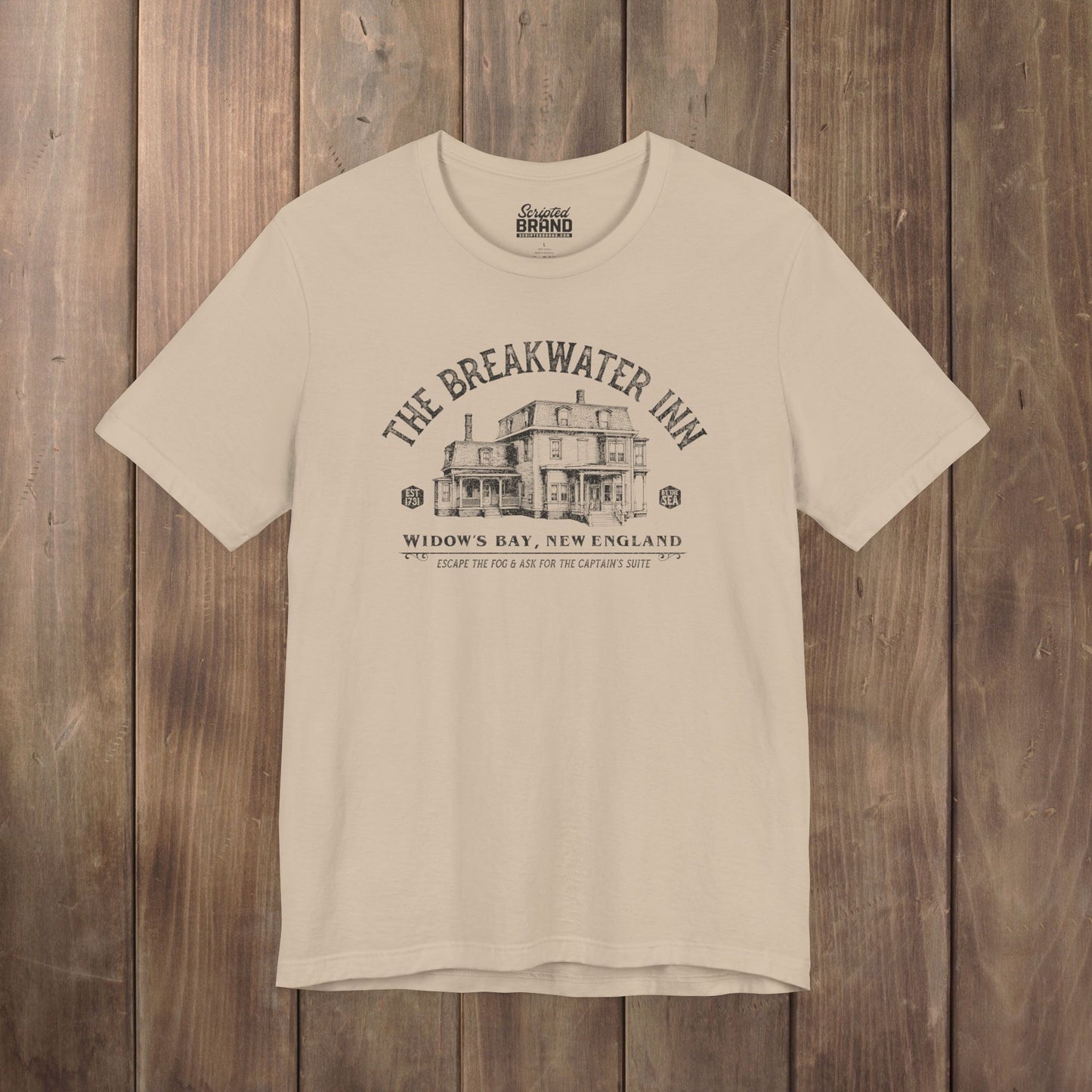 Tan 'The Breakwater Inn' vintage illustrated t-shirt inspired by Widow's Bay Apple TV series, soft Bella+Canvas cotton fan tee