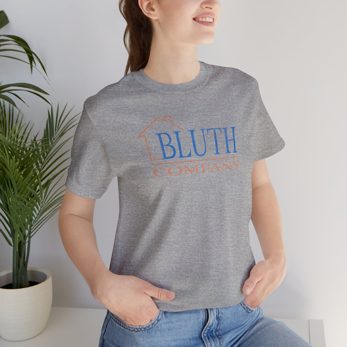female wearing athletic grey Bella+Canvas t-shirt featuring a vintage Bluth Company logo inspired by the TV show Arrested Development