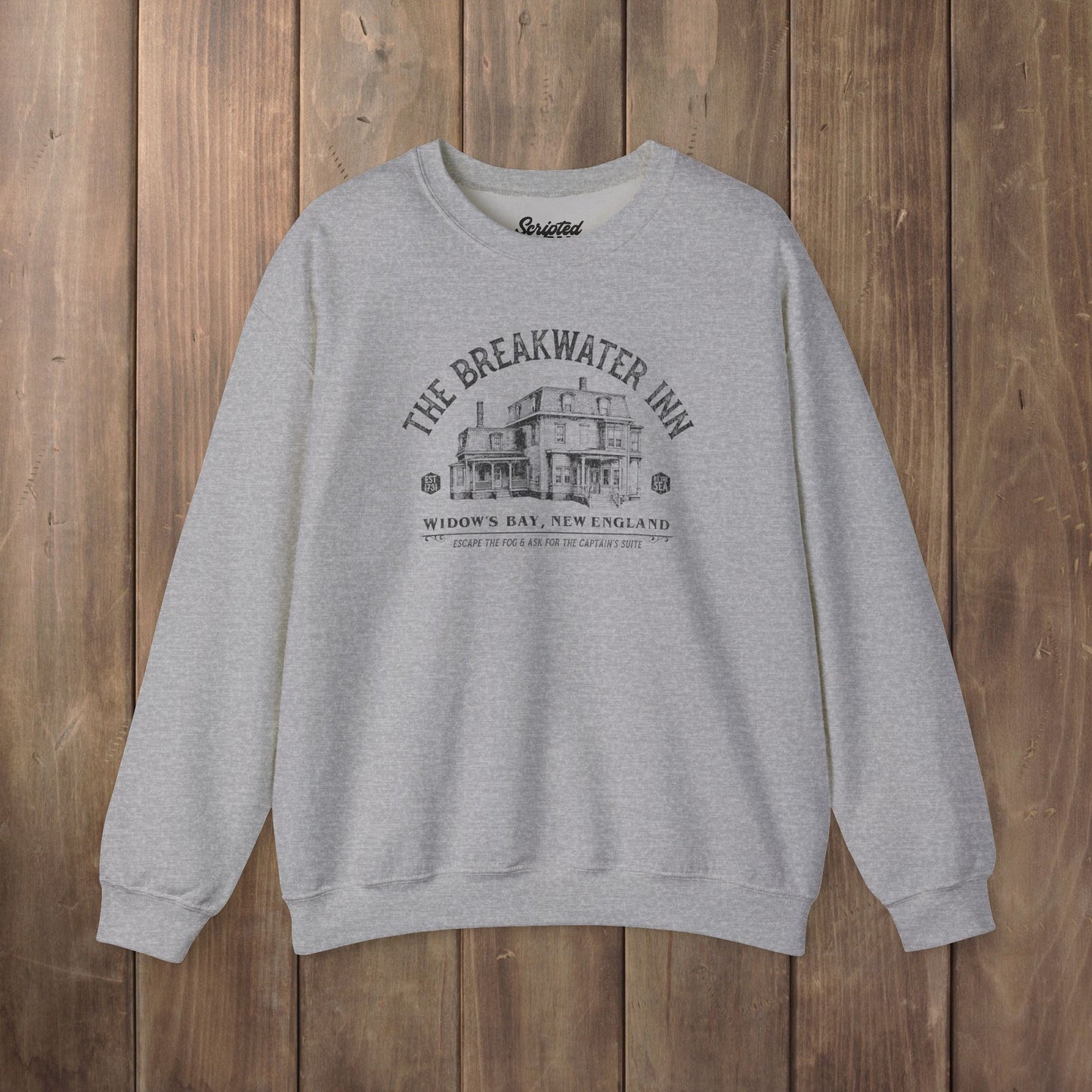 Heather gray crewneck sweatshirt with Breakwater Inn Widow's Bay New England hotel graphic