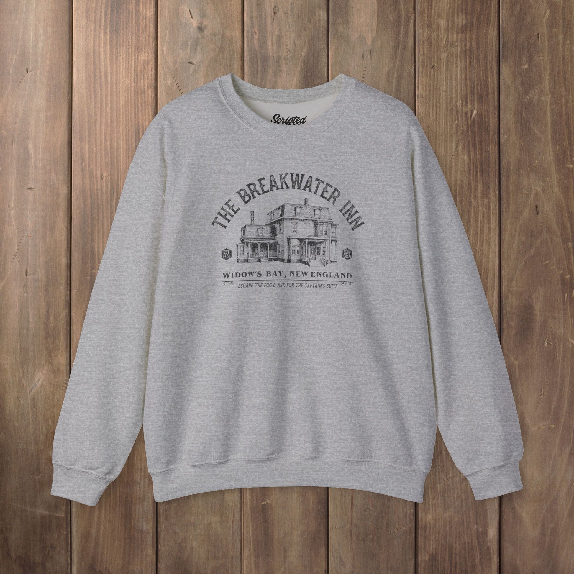 Heather gray crewneck sweatshirt with Breakwater Inn Widow's Bay New England hotel graphic