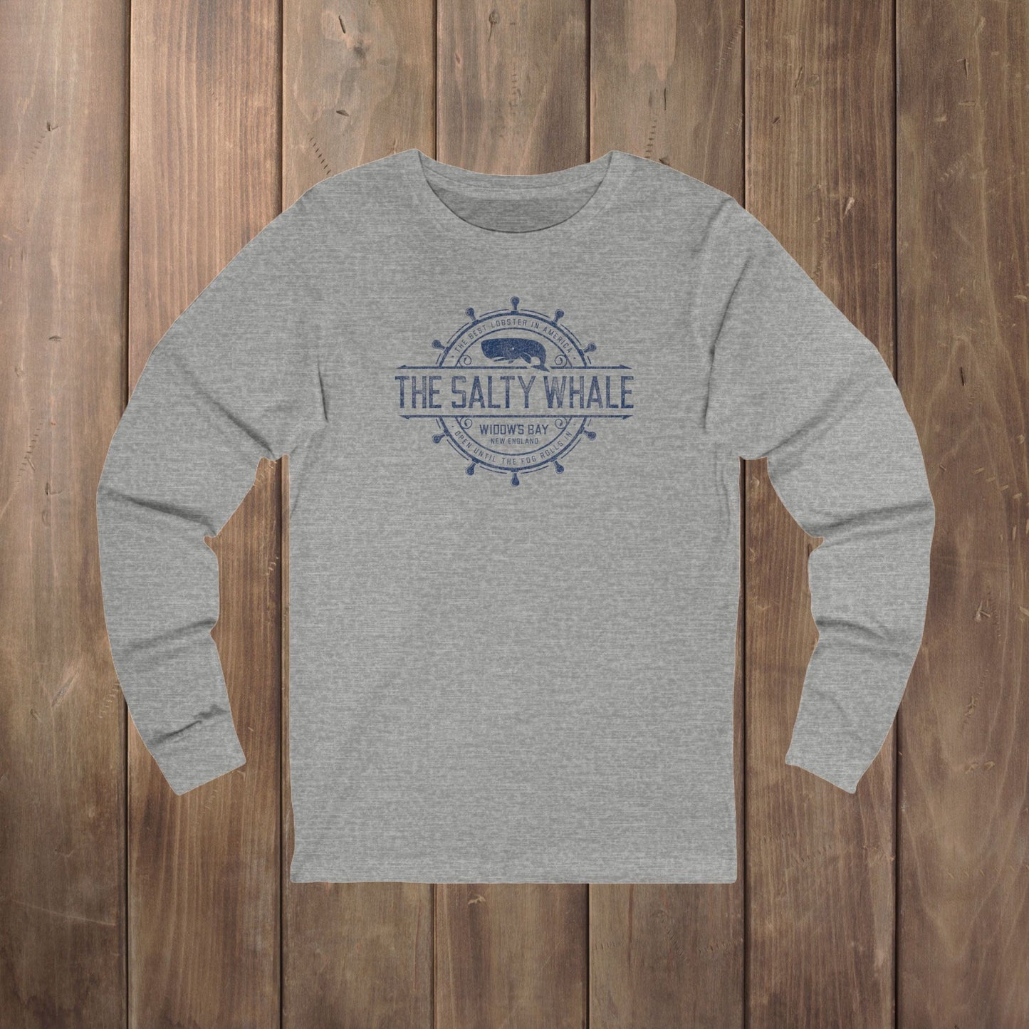 Heather gray long-sleeve tee with the gold distressed Salty Whale maritime crest logo from Widow's Bay, New England