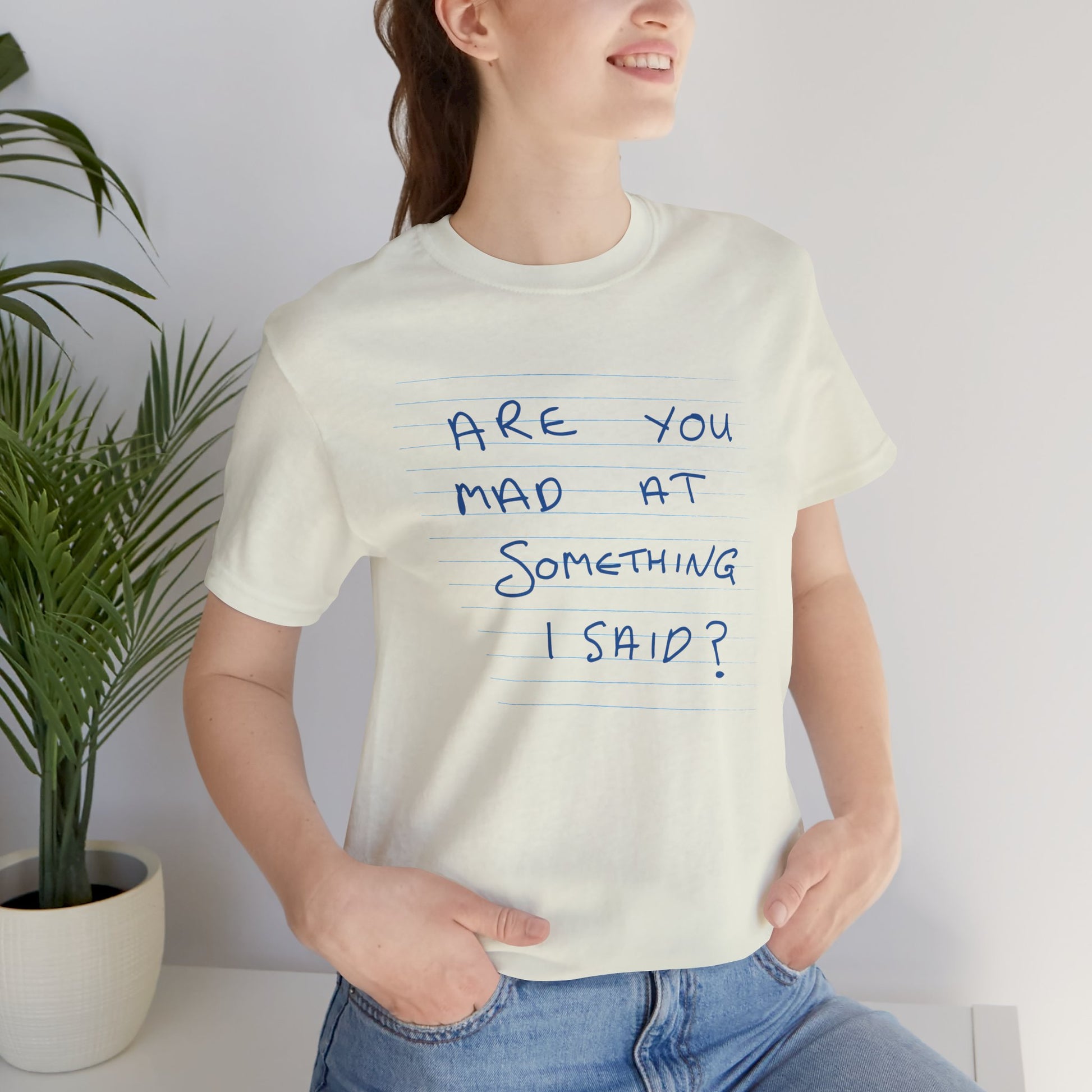 Person wearing t-shirt with handwritten Patricia note from Widow's Bay reading "Are You Mad At Something I Said?"