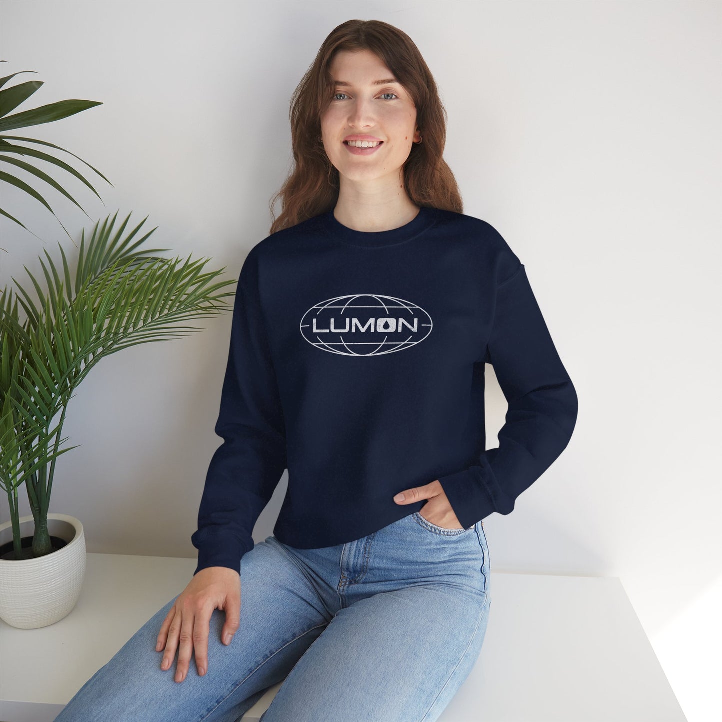 Female model wearing  a navy blue Soft Gildan 18000 crew neck sweatshirt featuring the Lumon Industries logo from the Apple TV show Severance in a vintage distressed style.