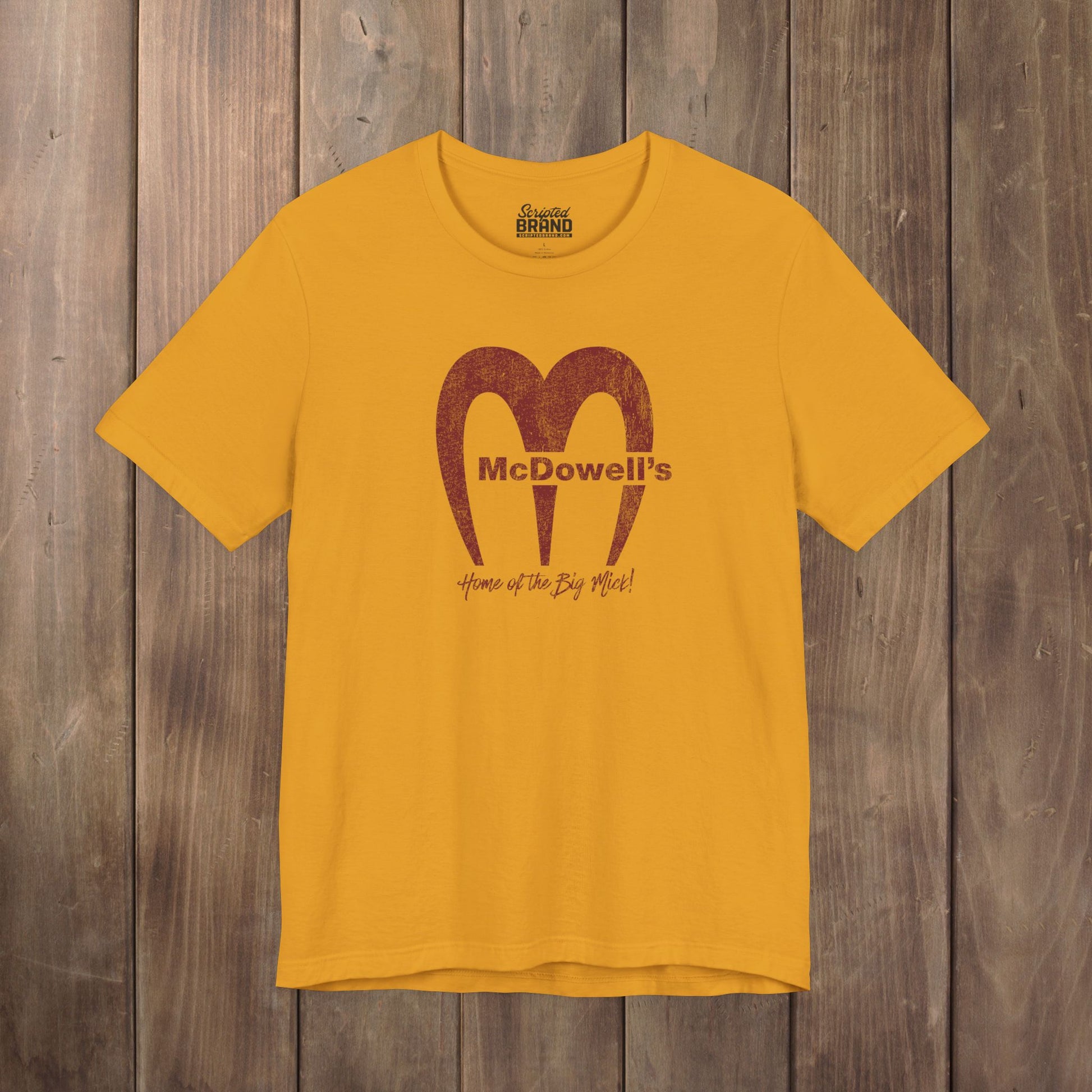 Gold yellow Bella+Canvas t-shirt featuring the McDowells logo from the movie Coming to America in a vintage distressed style.