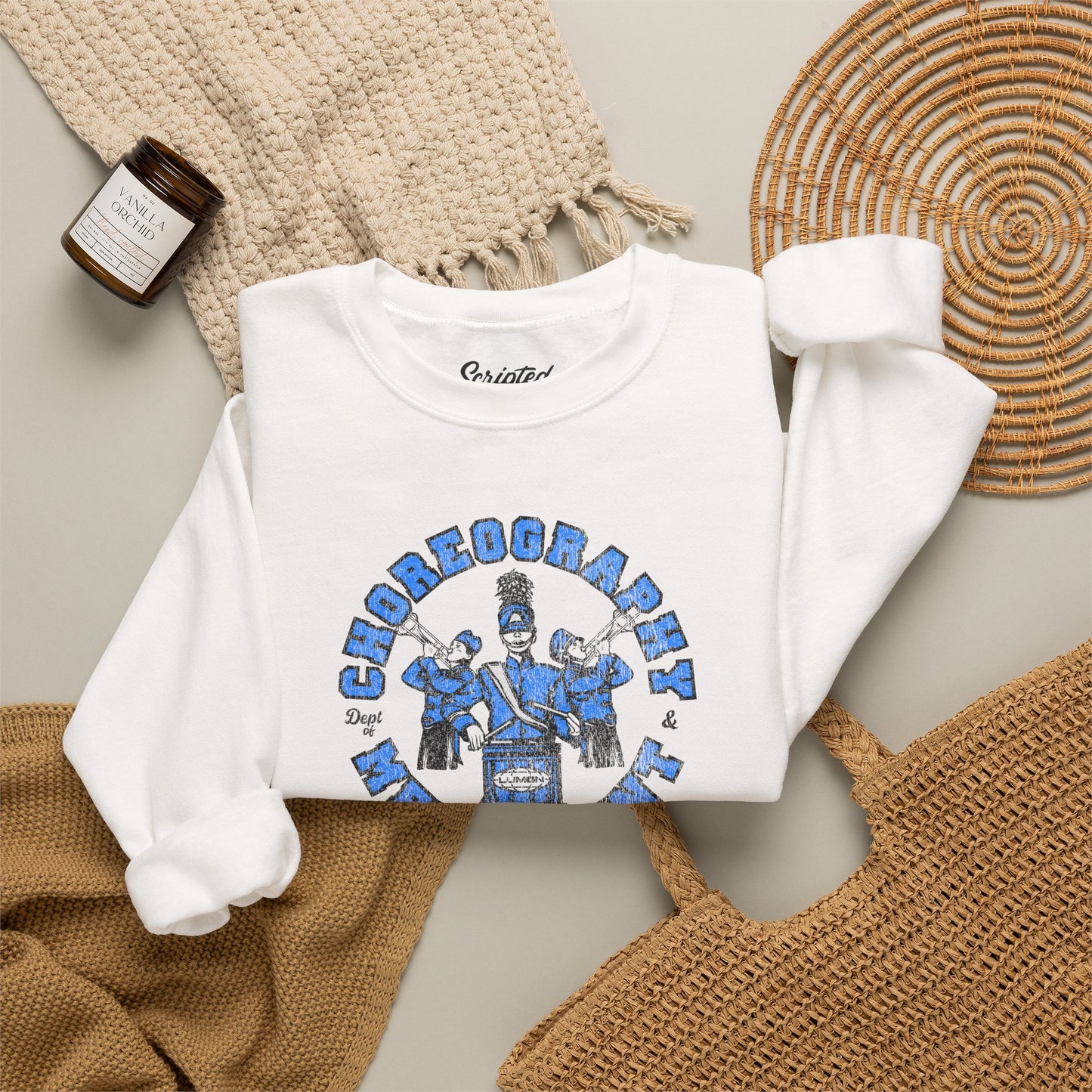 Folded white crewneck sweatshirt with vintage Lumon Choreography and Merriment marching band art from Severance.