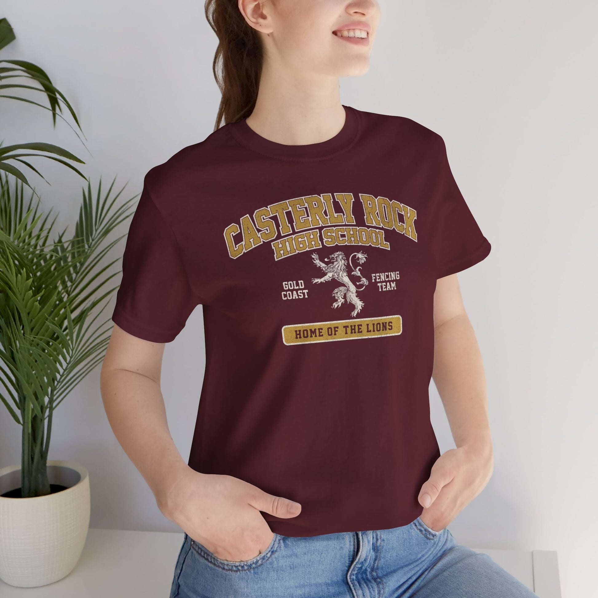 Woman wearing maroon Casterly Rock High School t-shirt with vintage lion graphic inspired by Game of Thrones.