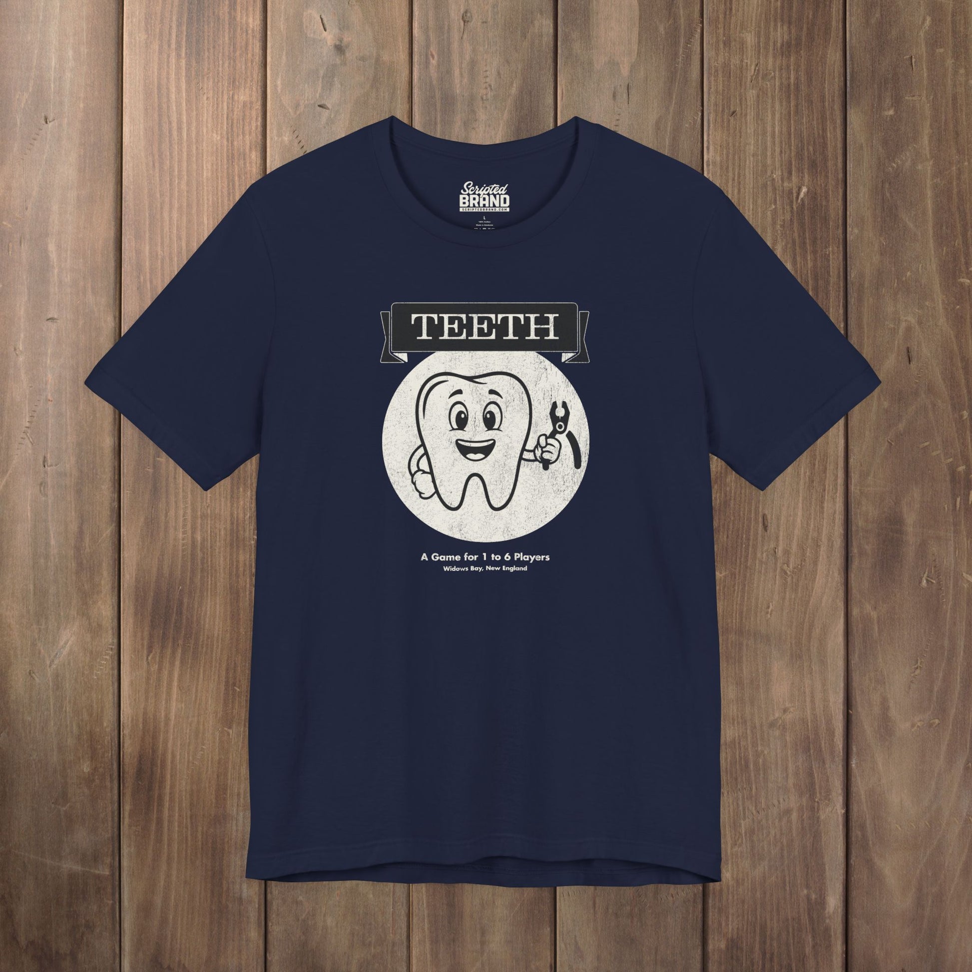 Navy blue green Bella+Canvas tee with the vintage TEETH board game box cover from Widow's Bay, a smiling tooth holding pliers