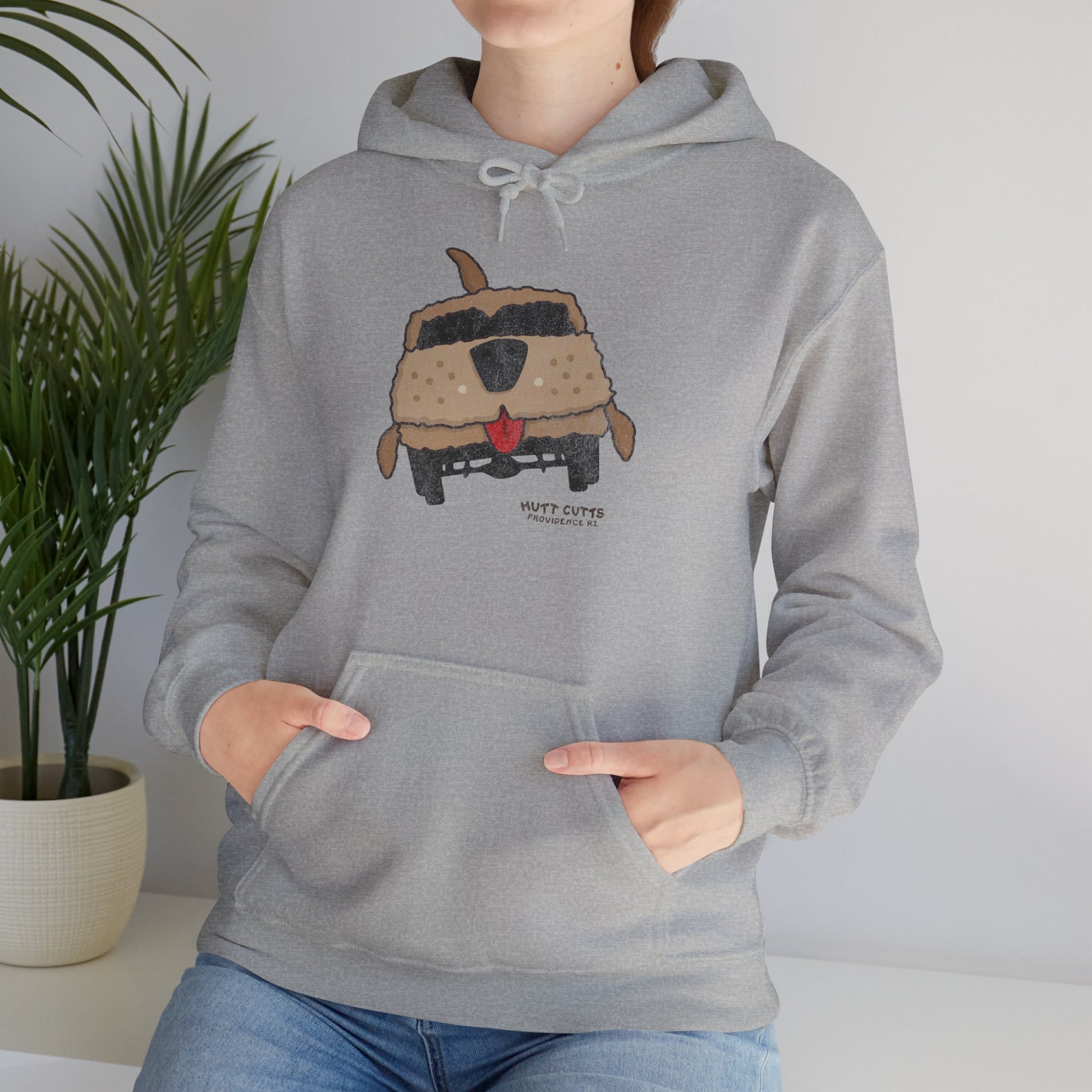 Woman wearing heather gray colored Gildan 18500 hoodie with vintage distressed Mutt Cutts dog van graphic inspired by Dumb and Dumber movie.