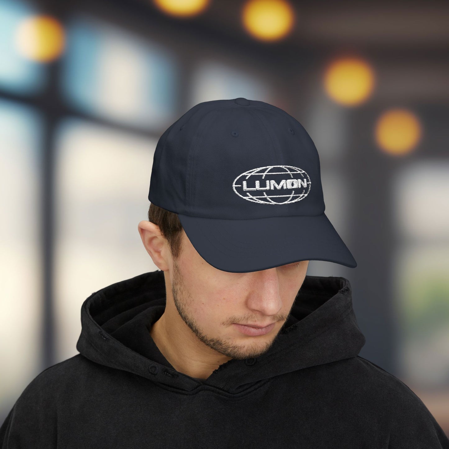 Man wearing navy dad hat with white embroidered Lumon Industries globe logo, Severance-inspired design cap