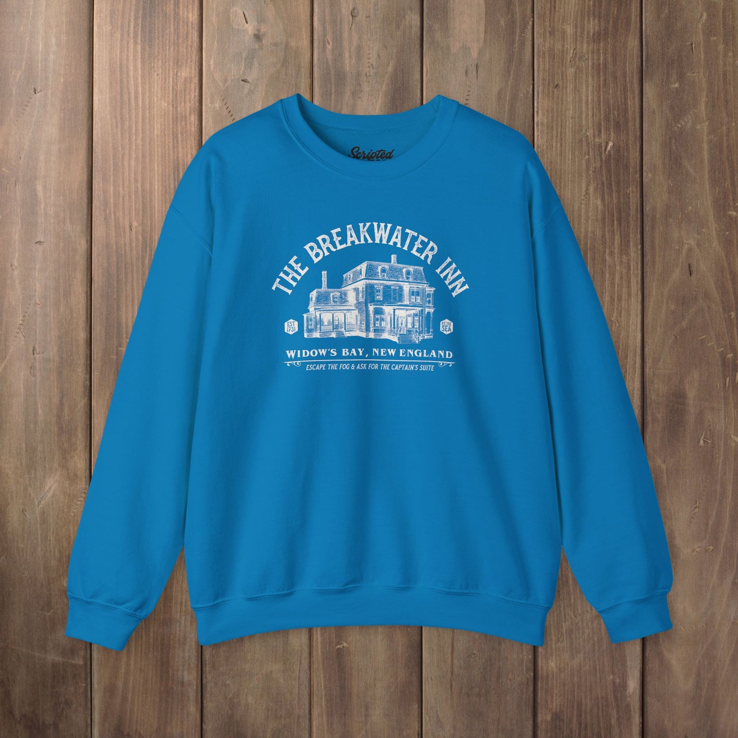 Sapphire blue crewneck sweatshirt with Breakwater Inn Widow's Bay New England hotel graphic