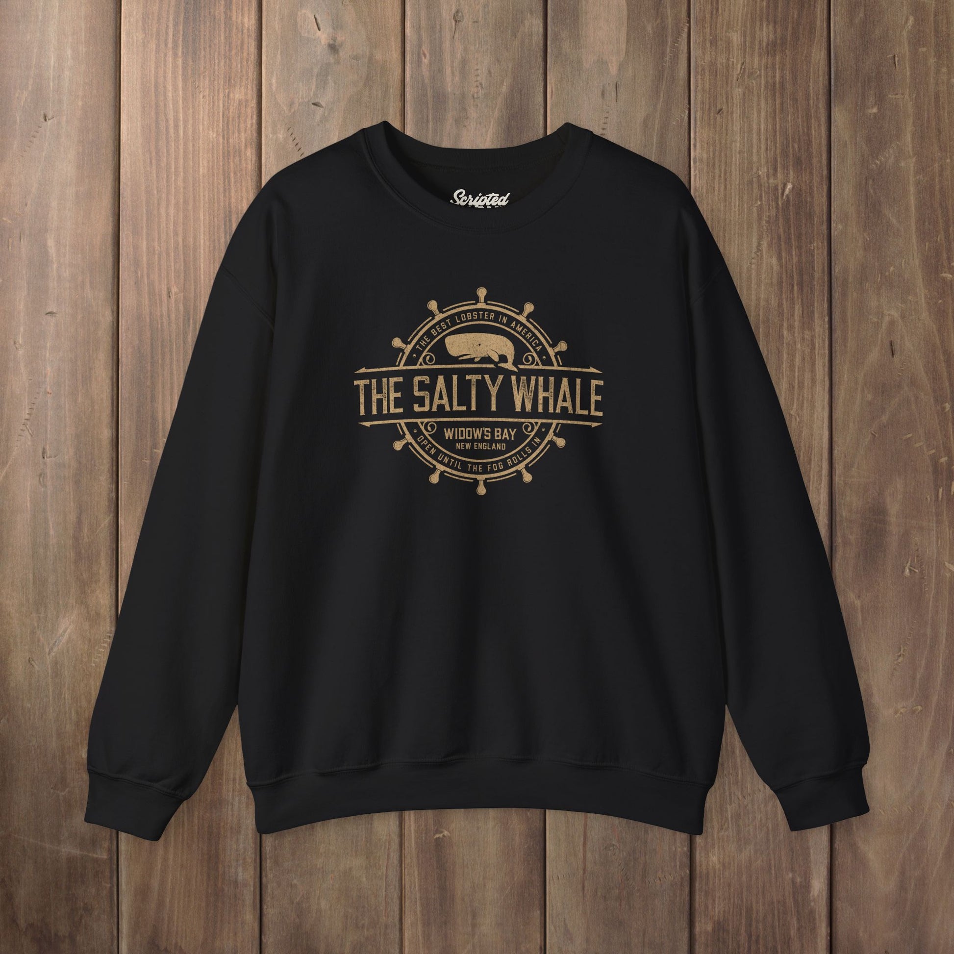 Black Gildan crewneck sweatshirt with the distressed Salty Whale maritime crest logo from TV show Widow's Bay
