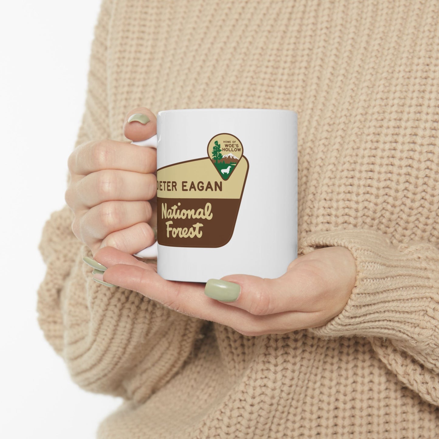 Female holding 11 oz White ceramic mug with Dieter Eagan National Forest logo, inspired by Woe’s Hollow episode in Severance.