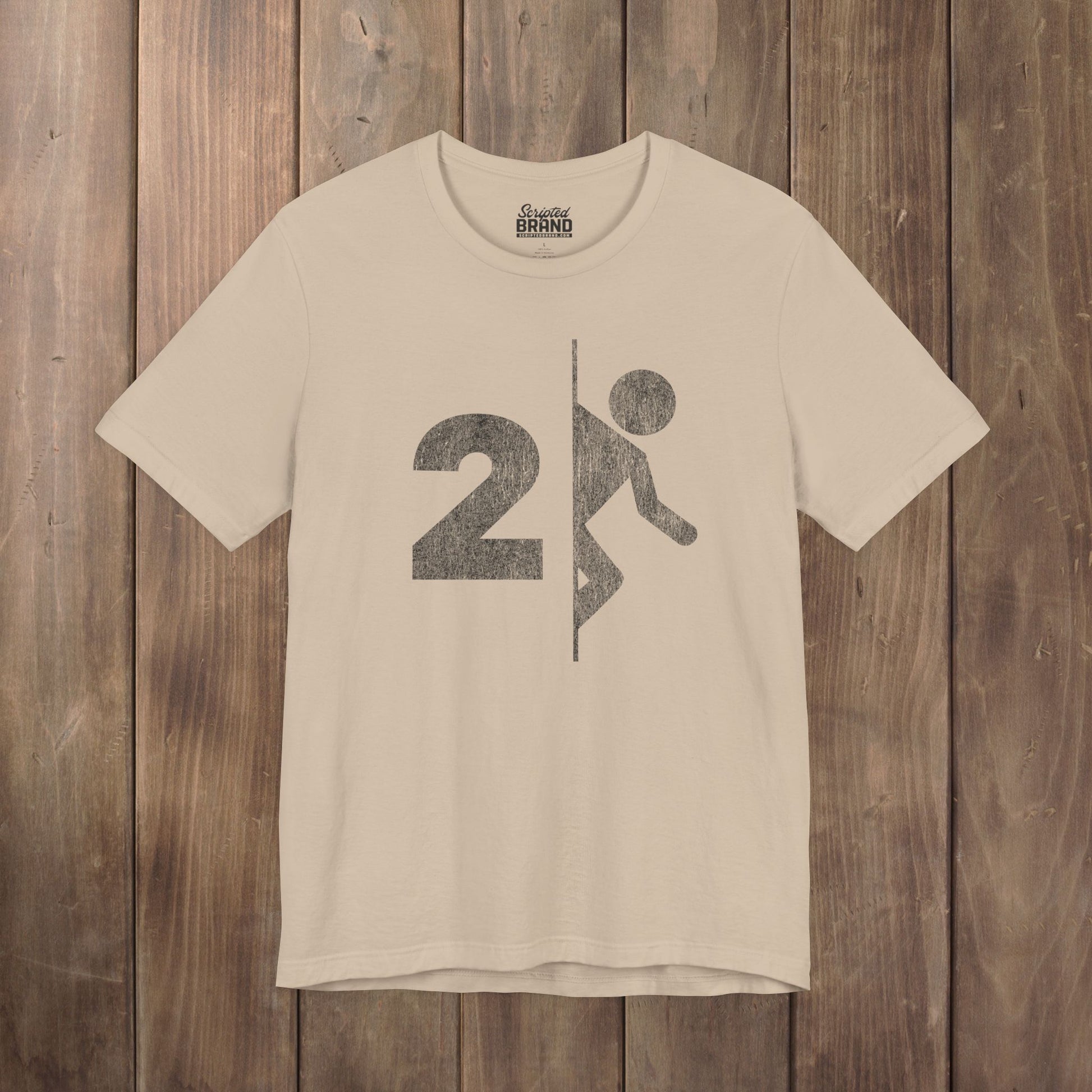 Tan tee with vintage distressed Portal 2 partial logo figure diving through a portal, aperture labs