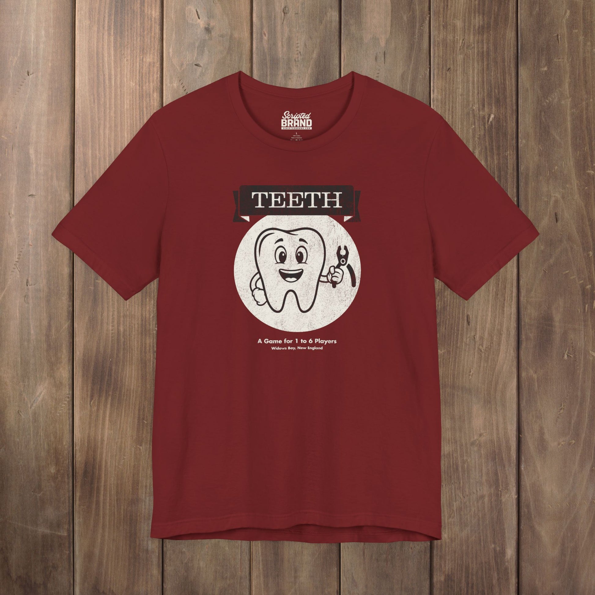 Red Bella+Canvas tee with the vintage TEETH board game box cover from Widow's Bay, a smiling tooth holding pliers