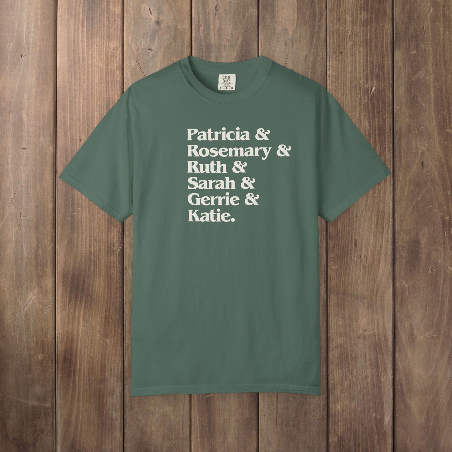 Blue Spruce green Comfort Colors tee listing the women of Widow's Bay: Patricia, Rosemary, Ruth, Sarah, Gerrie, and Katie