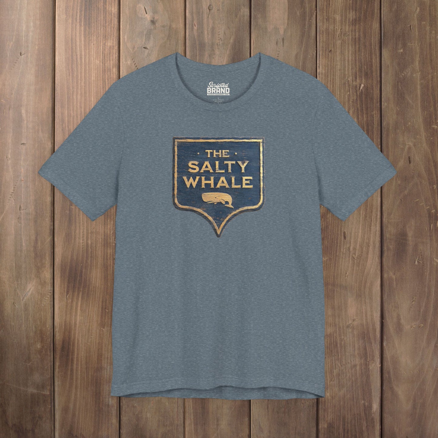 Heather slate blue 'The Salty Whale' weathered carved-wood pub sign t-shirt inspired by Widow's Bay Apple TV series, heather Bella+Canvas tee