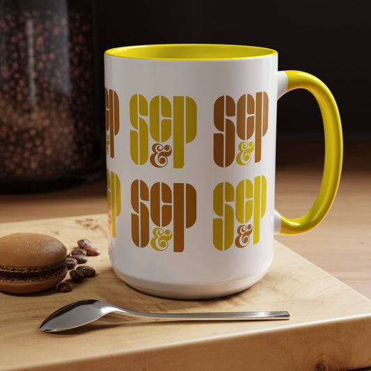 Kitchen view of a Mad Men 15 ounce white and yellow ceramic mug with a wraparound graphic of Sterling Cooper & Partners logos