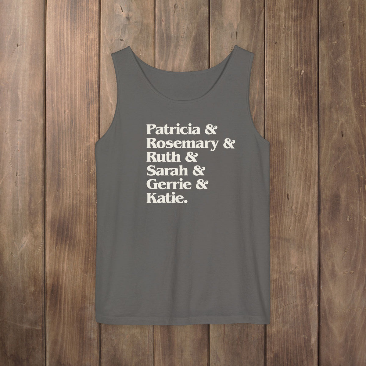 Pepper gray garment-dyed Comfort Colors tank top with stacked Women of Widow's Bay show names in ampersand list including Patricia, Ruth, Rosemary