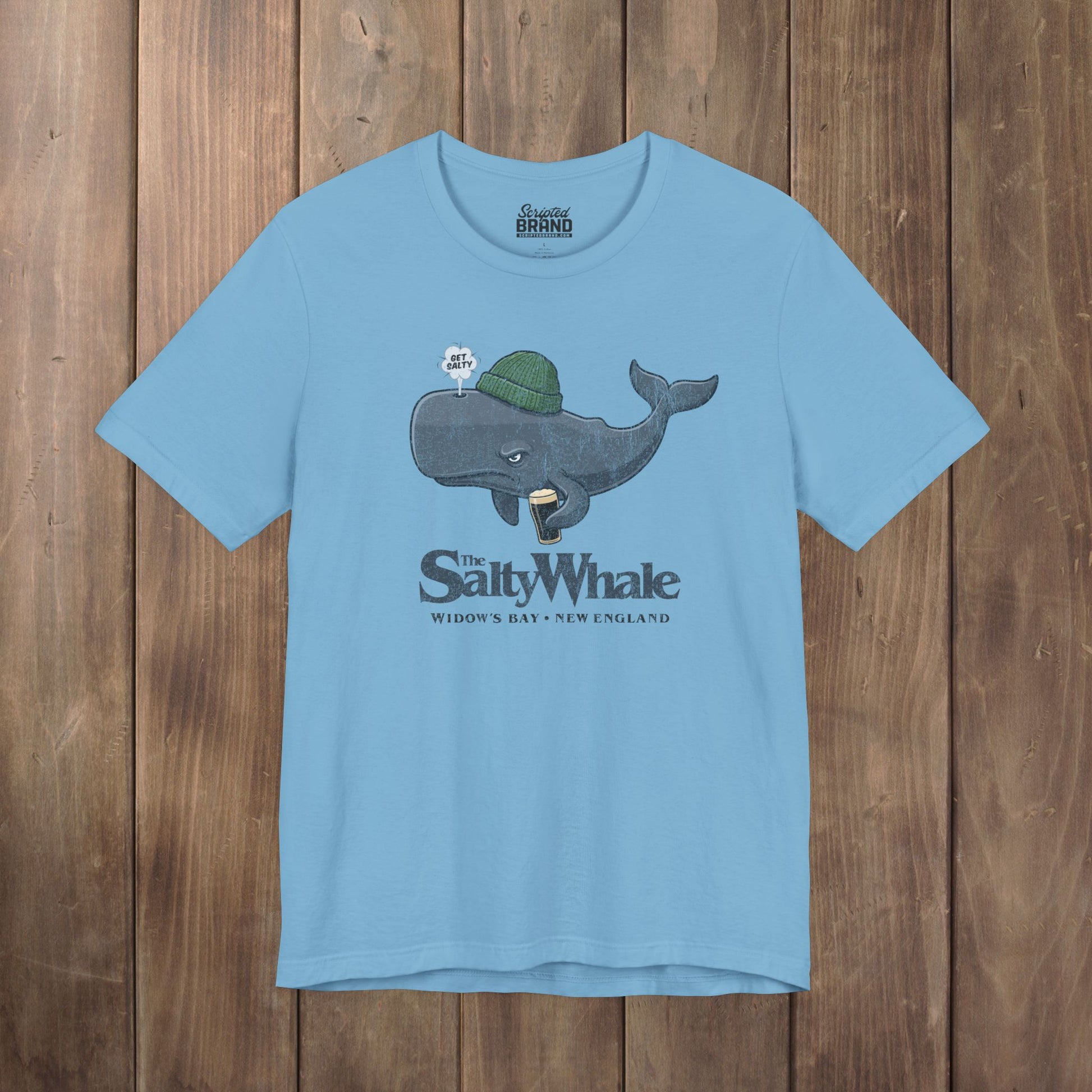 Ocean blue 'The Salty Whale' cartoon mascot t-shirt inspired by Widow's Bay Apple TV series, soft Bella+Canvas cotton pub fan tee