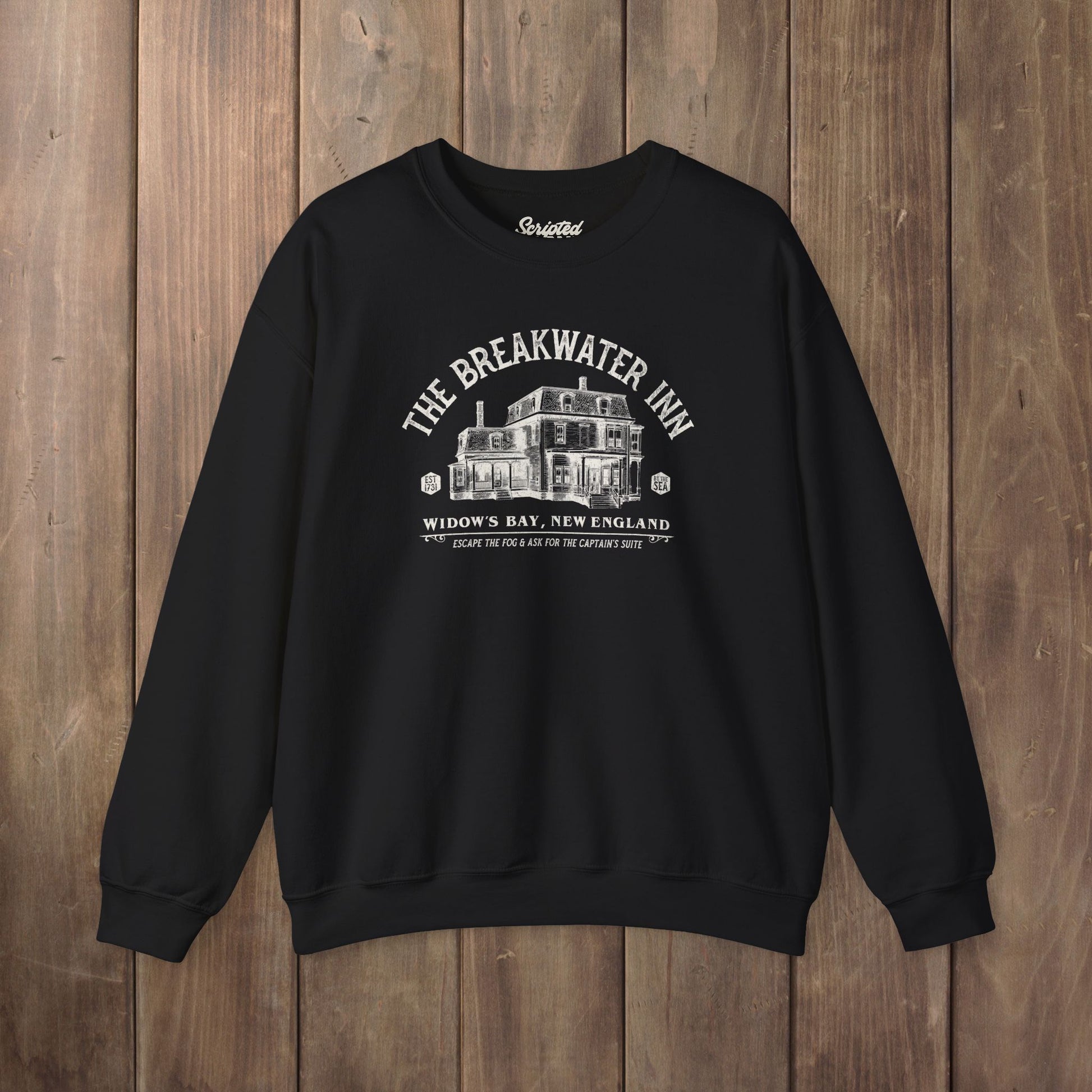 Black crewneck sweatshirt with Breakwater Inn Widow's Bay New England hotel graphic