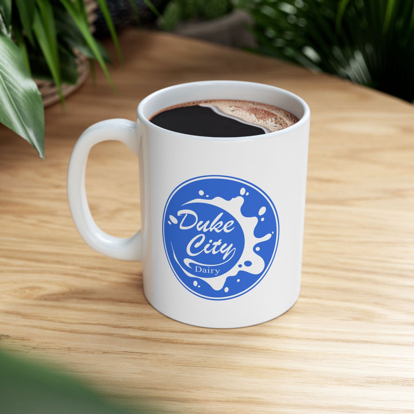 White mug with 'Duke City Dairy' logo from Pluribus on a wooden table