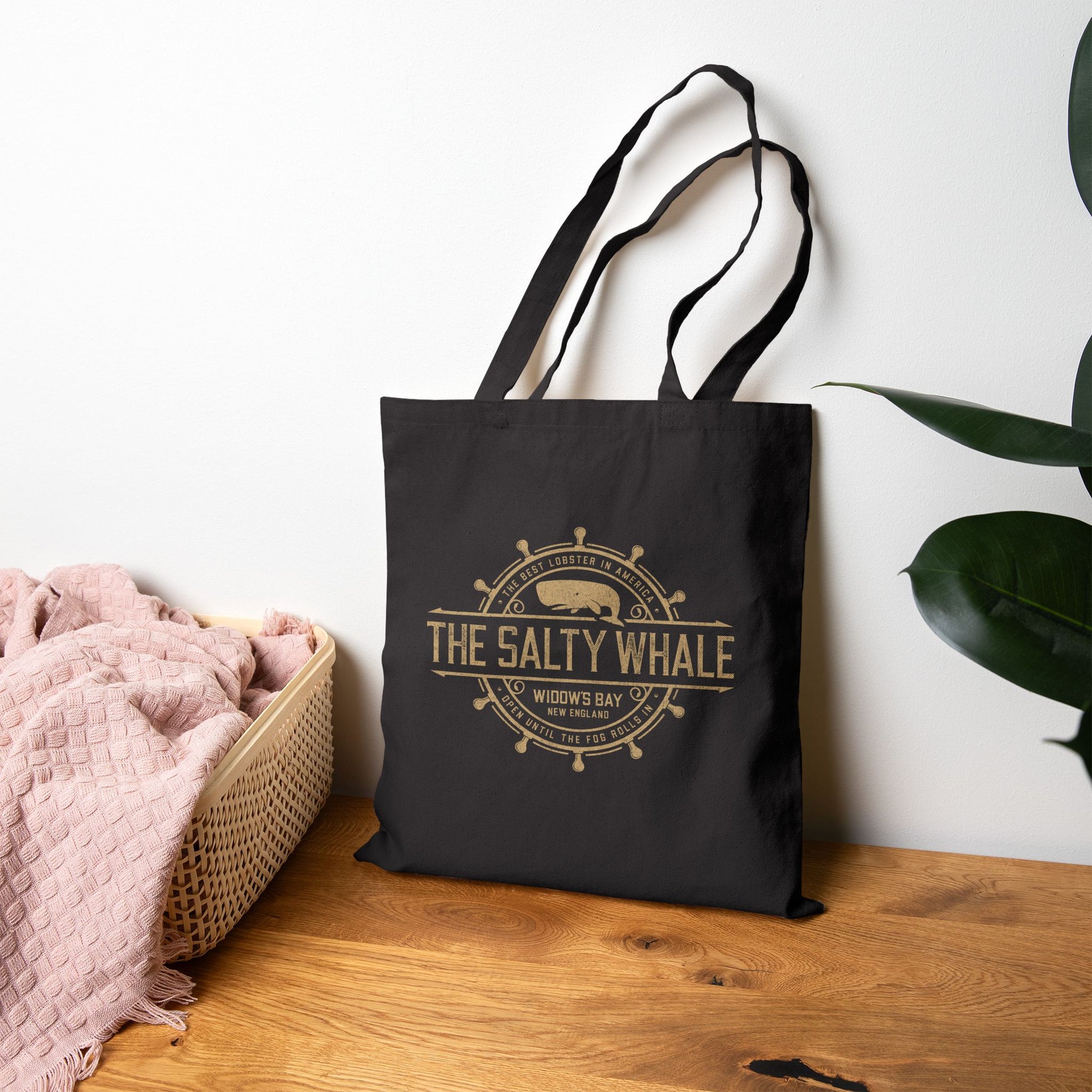 Black canvas tote bag on floor with vintage The Salty Whale, Widow's Bay TV show nautical grocery shopping