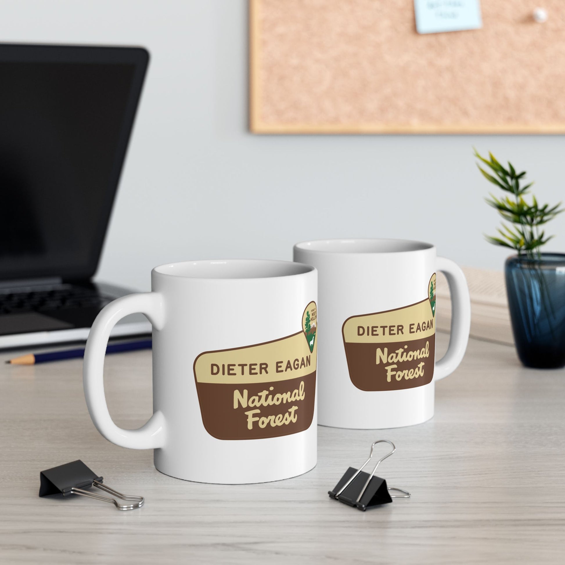 2 White ceramic mugs with Dieter Eagan National Forest logo, inspired by Woe’s Hollow episode in Severance.