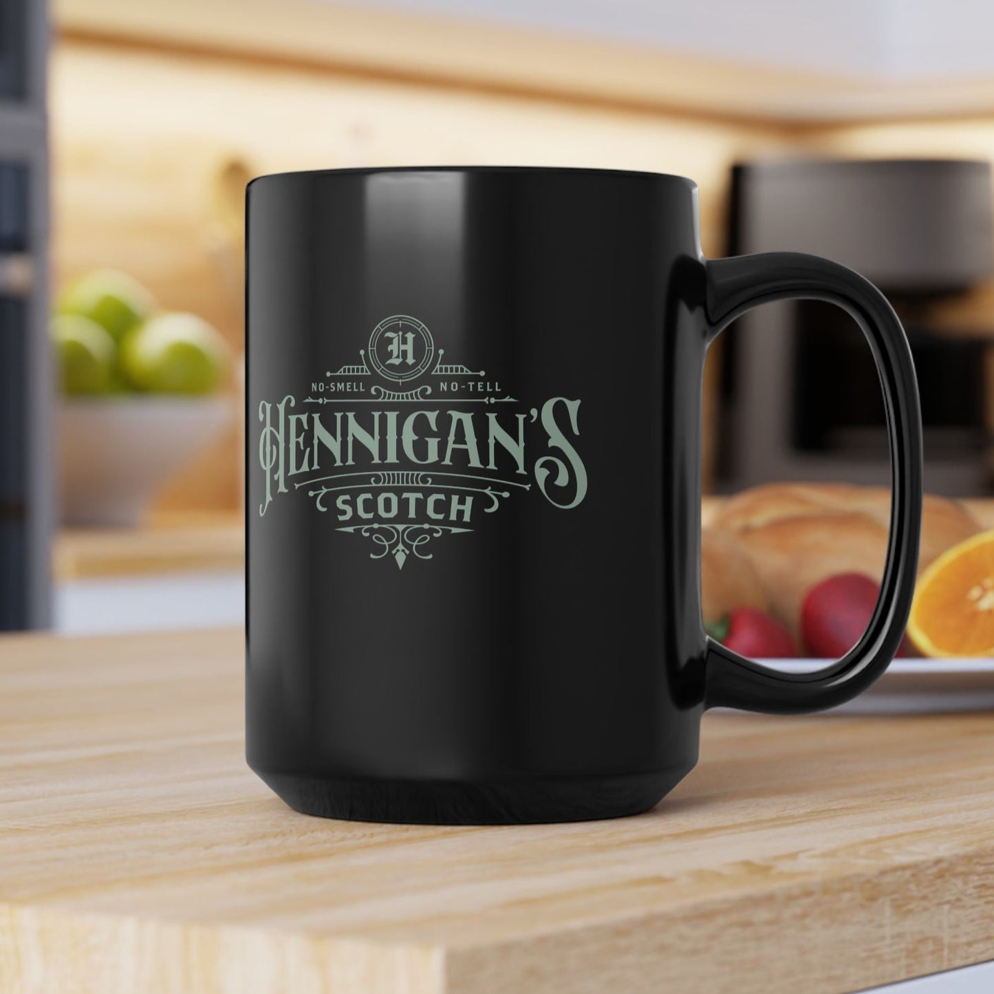 Black mug with 'Hennigan's Scotch' text on a kitchen counter