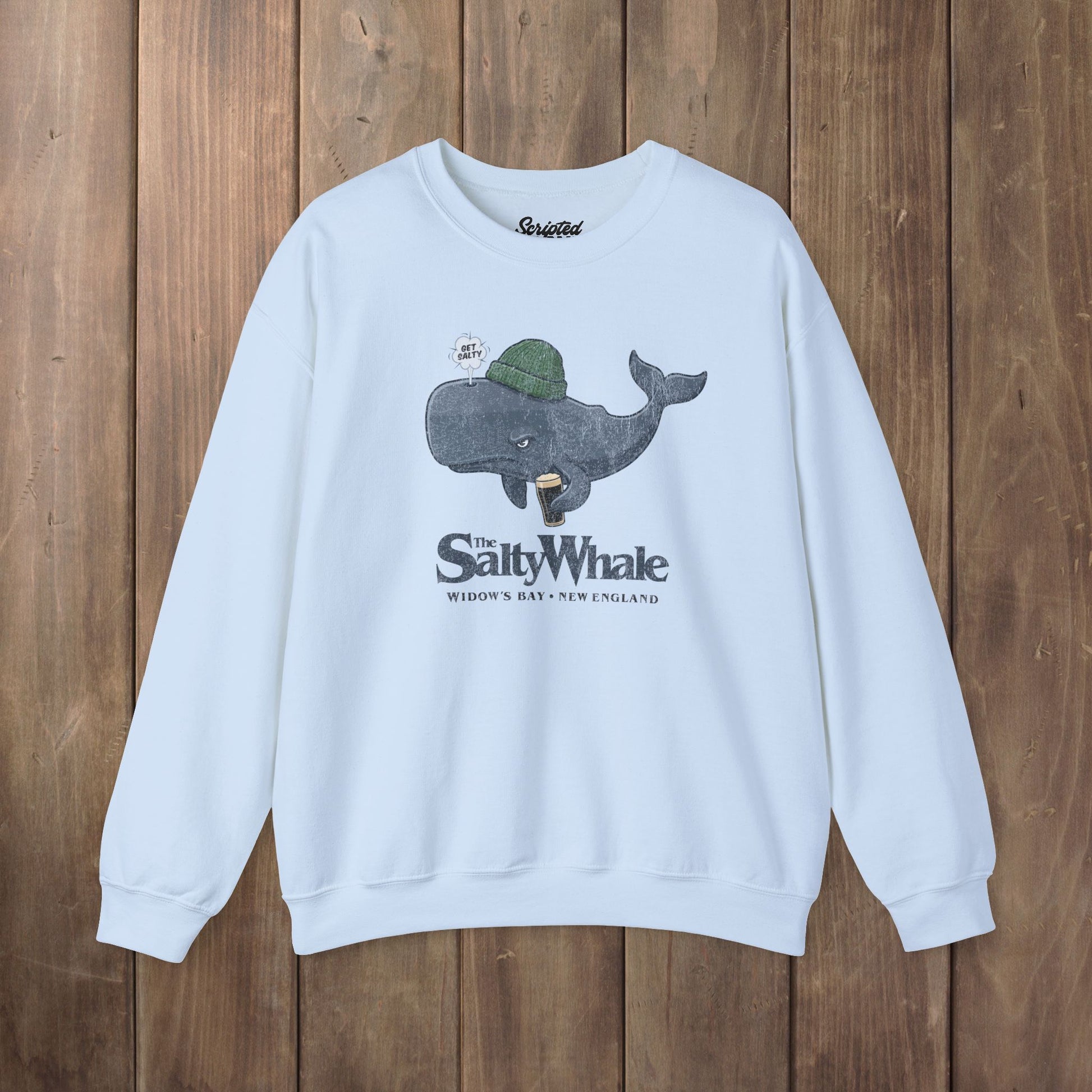 Light blue colored The Salty Whale cartoon mascot crewneck sweatshirt inspired by Widow's Bay Apple TV series, vintage pub fan pullover