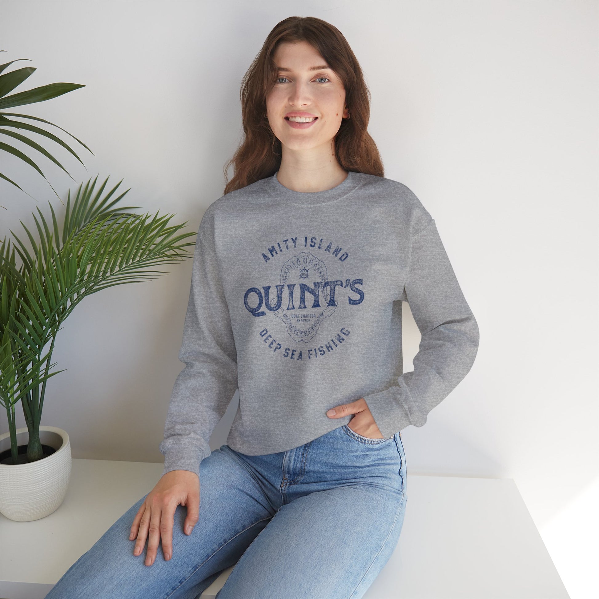 female wearing athletic grey sweatshirt with Quint's Deep Sea Fishing logo from the movie Jaws in vintage distressed style.
