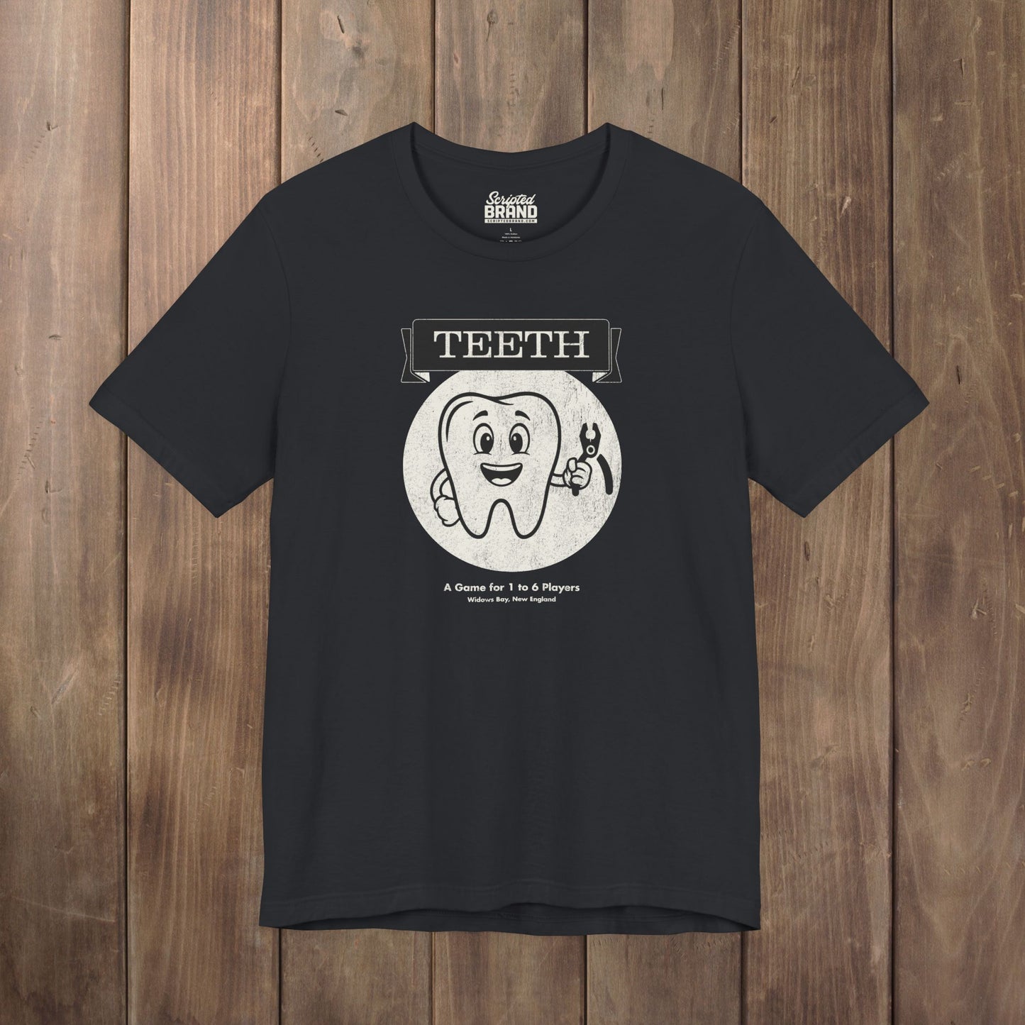 Black Bella+Canvas tee with the vintage TEETH board game box cover from Widow's Bay, a smiling tooth holding pliers