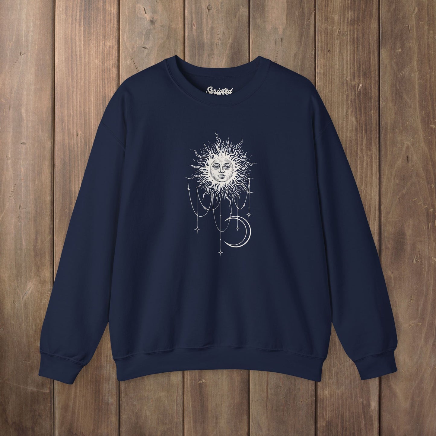 Navy blue crewneck sweatshirt with boho celestial sun face, stars, and crescent moon design worn by Patricia in Widow's Bay