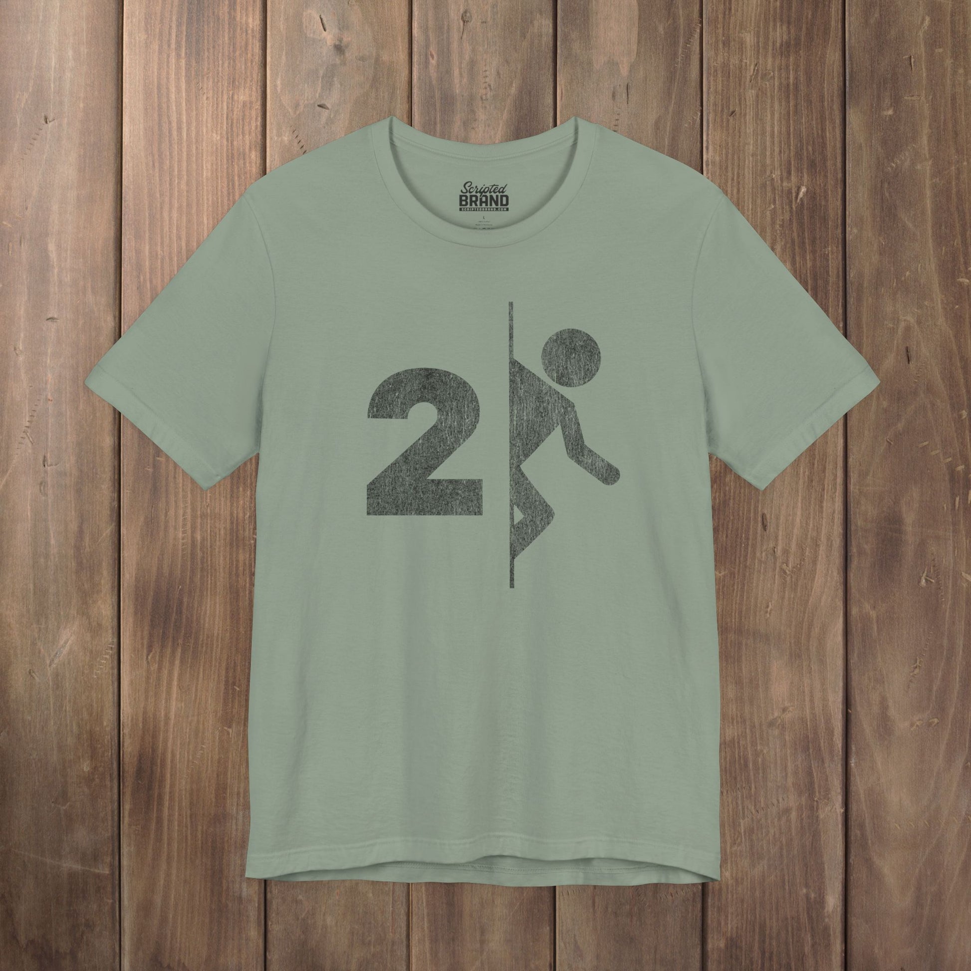 Sage green tee with vintage distressed Portal 2 partial logo figure diving through a portal, aperture labs