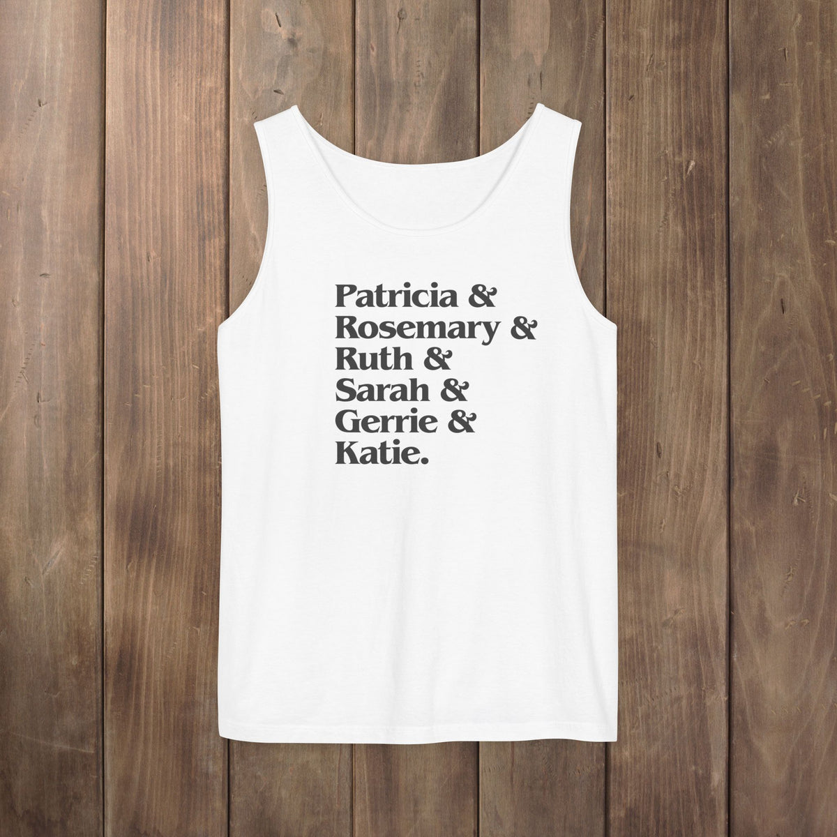 White garment-dyed Comfort Colors tank top with stacked Women of Widow's Bay show names in ampersand list including Patricia, Ruth, Rosemary