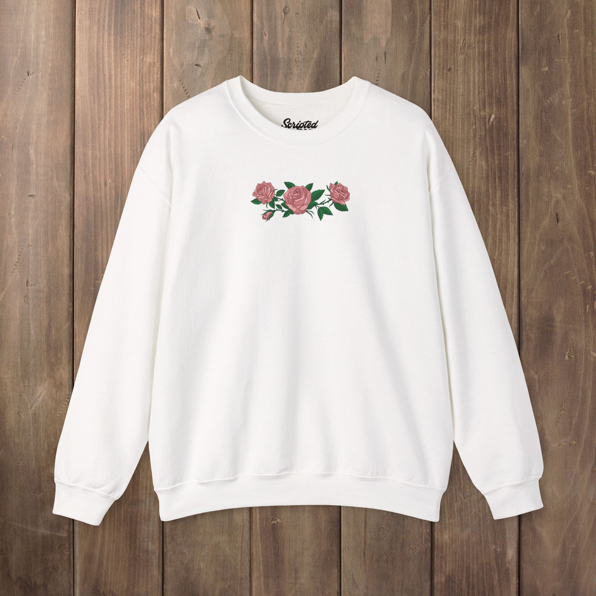 White crewneck sweatshirt with three pink roses and green leaves printed across the chest, inspired by Ruth of Widow's Bay