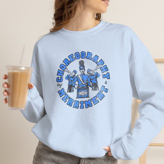 Woman wearing Light blue crewneck sweatshirt with vintage Lumon Choreography and Merriment marching band art from Severance.