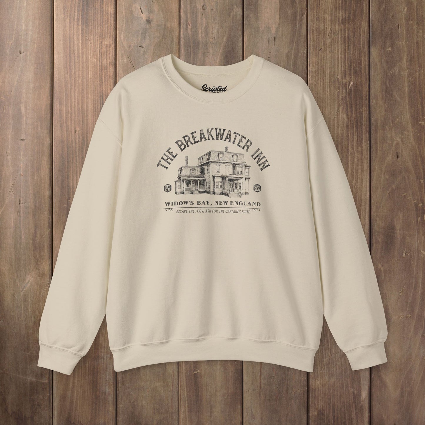 Sand beige crewneck sweatshirt with Breakwater Inn Widow's Bay New England hotel graphic