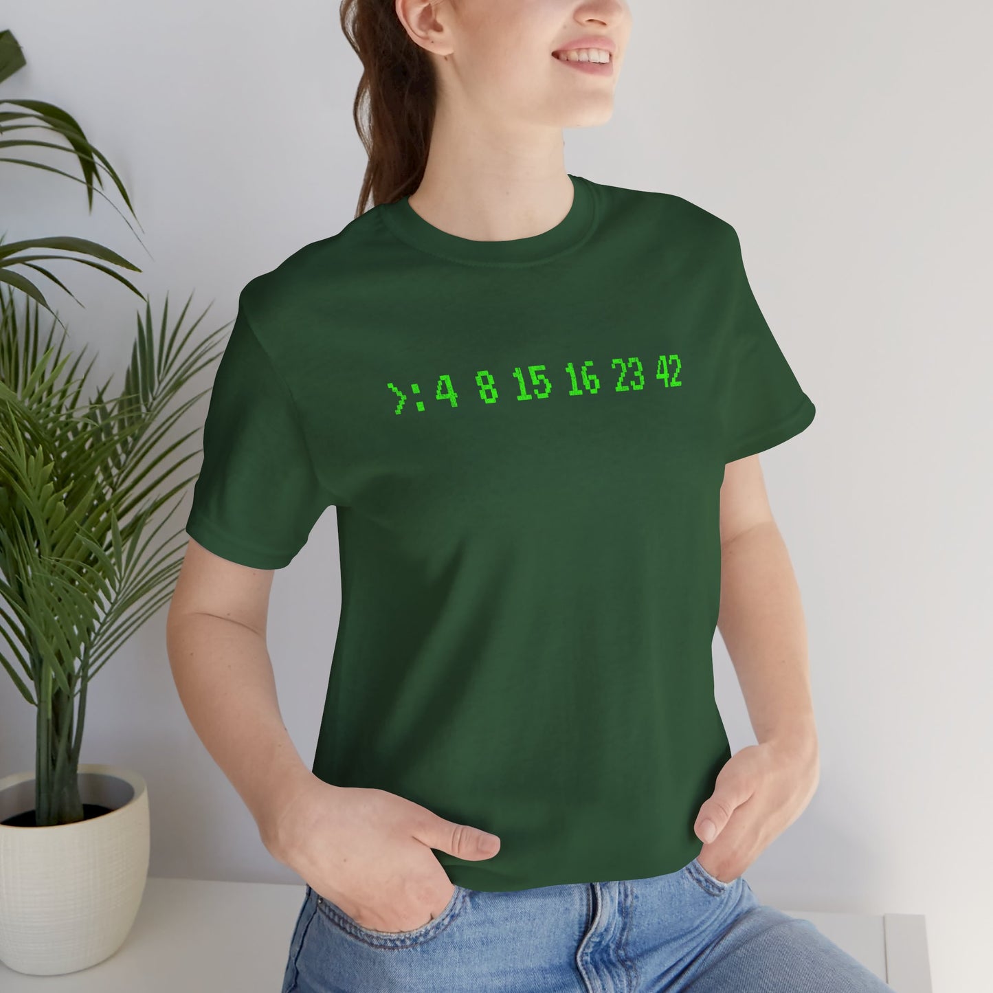 Woman wearing Green Bella+Canvas 3001 t-shirt with terminal green LOST Dharma Initiative hatch numbers 4 8 15 16 23 42