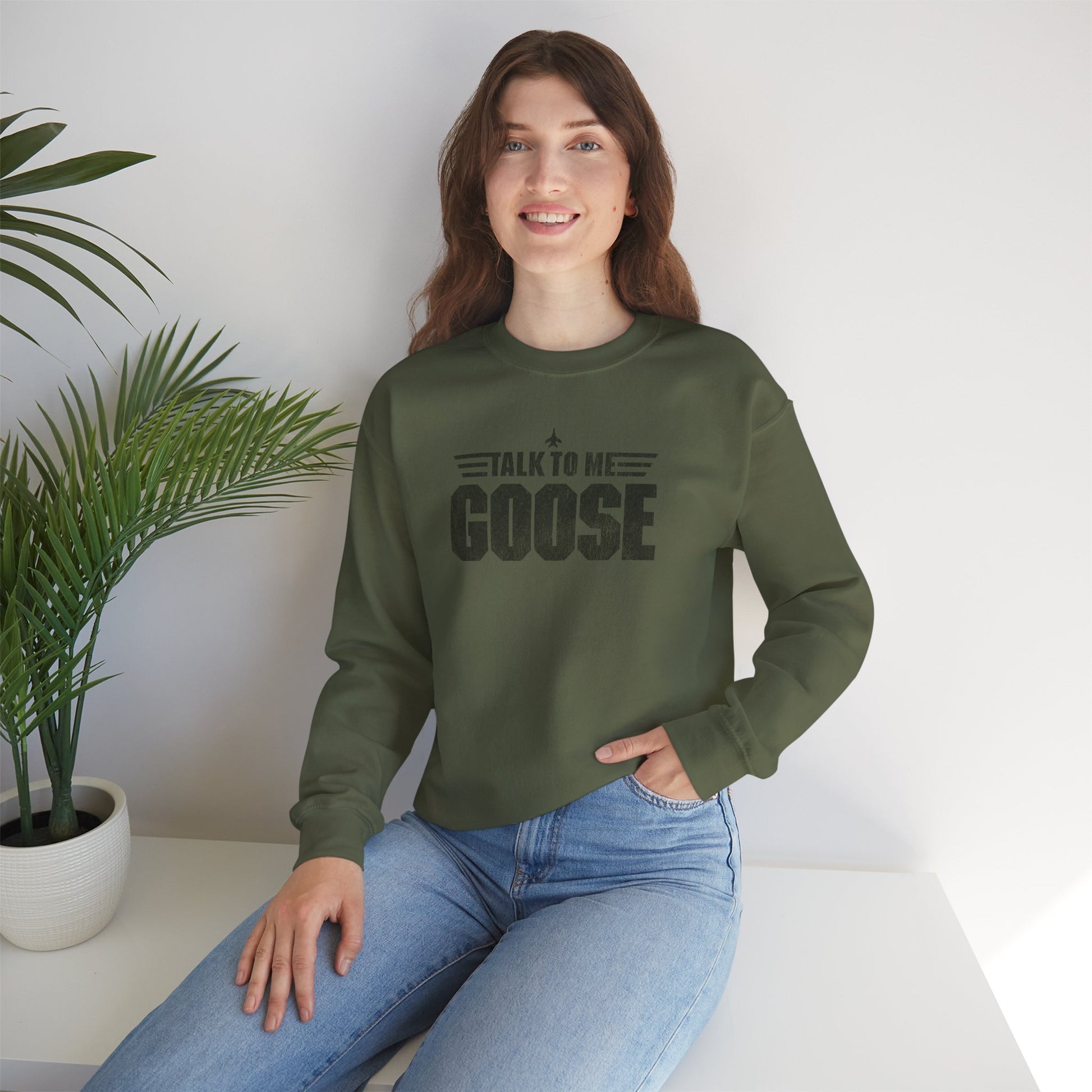 Female wearing Military green crewneck sweatshirt with distressed “Talk to Me Goose” graphic, inspired by the movie Top Gun.